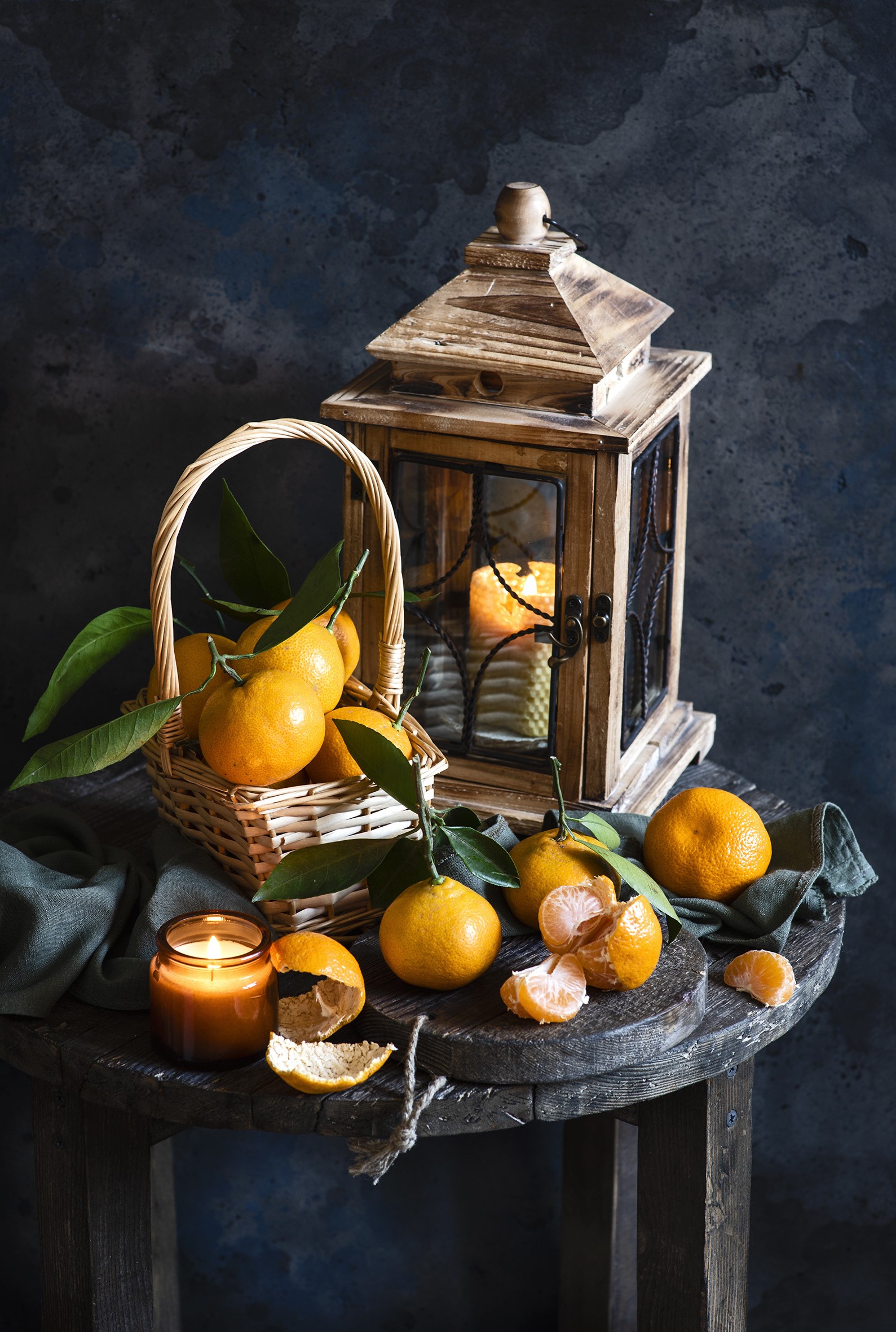 Tangerines in a basket with a lantern and candle HD Phone Wallpaper