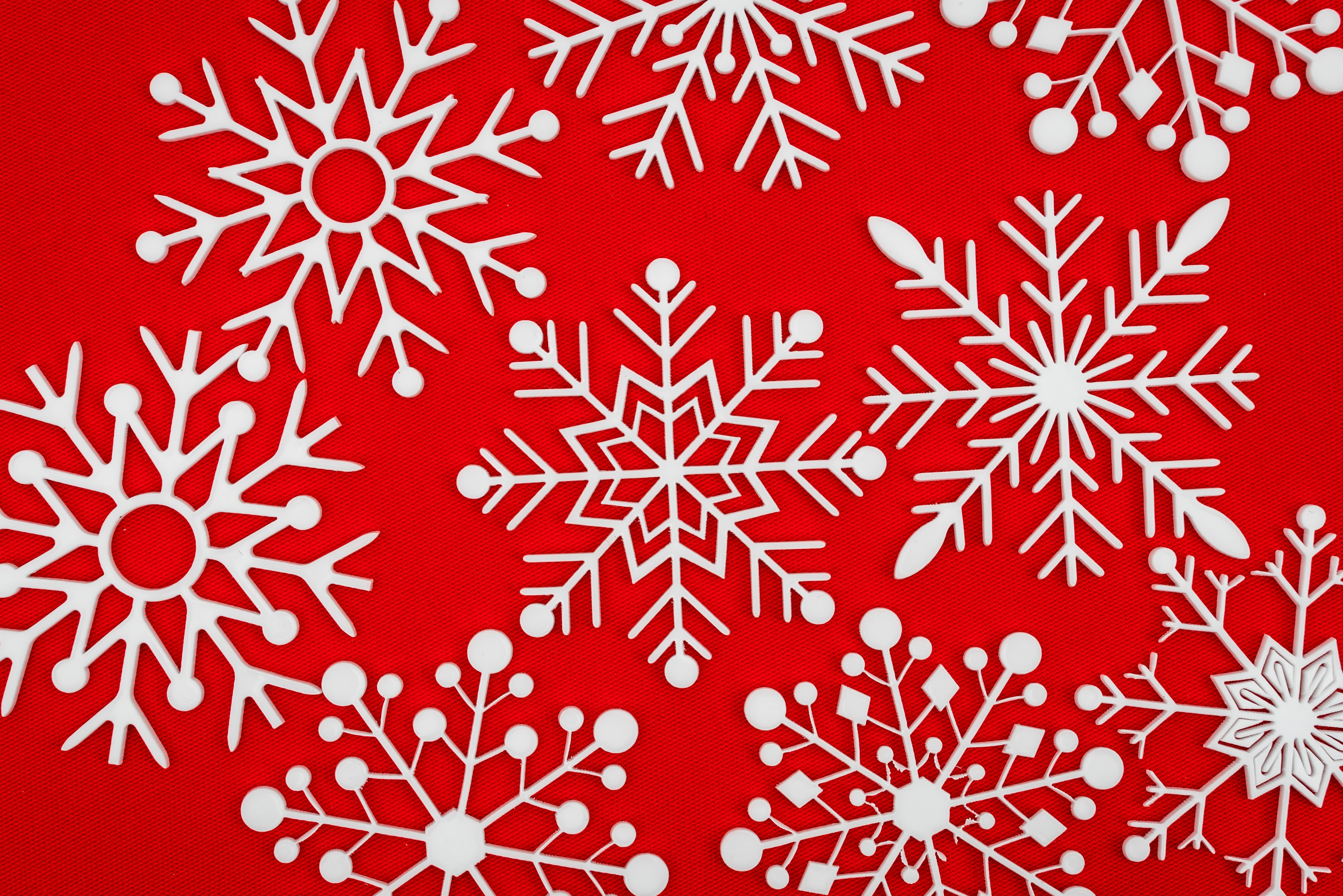 White snowflakes on a red textured background HD Wallpaper