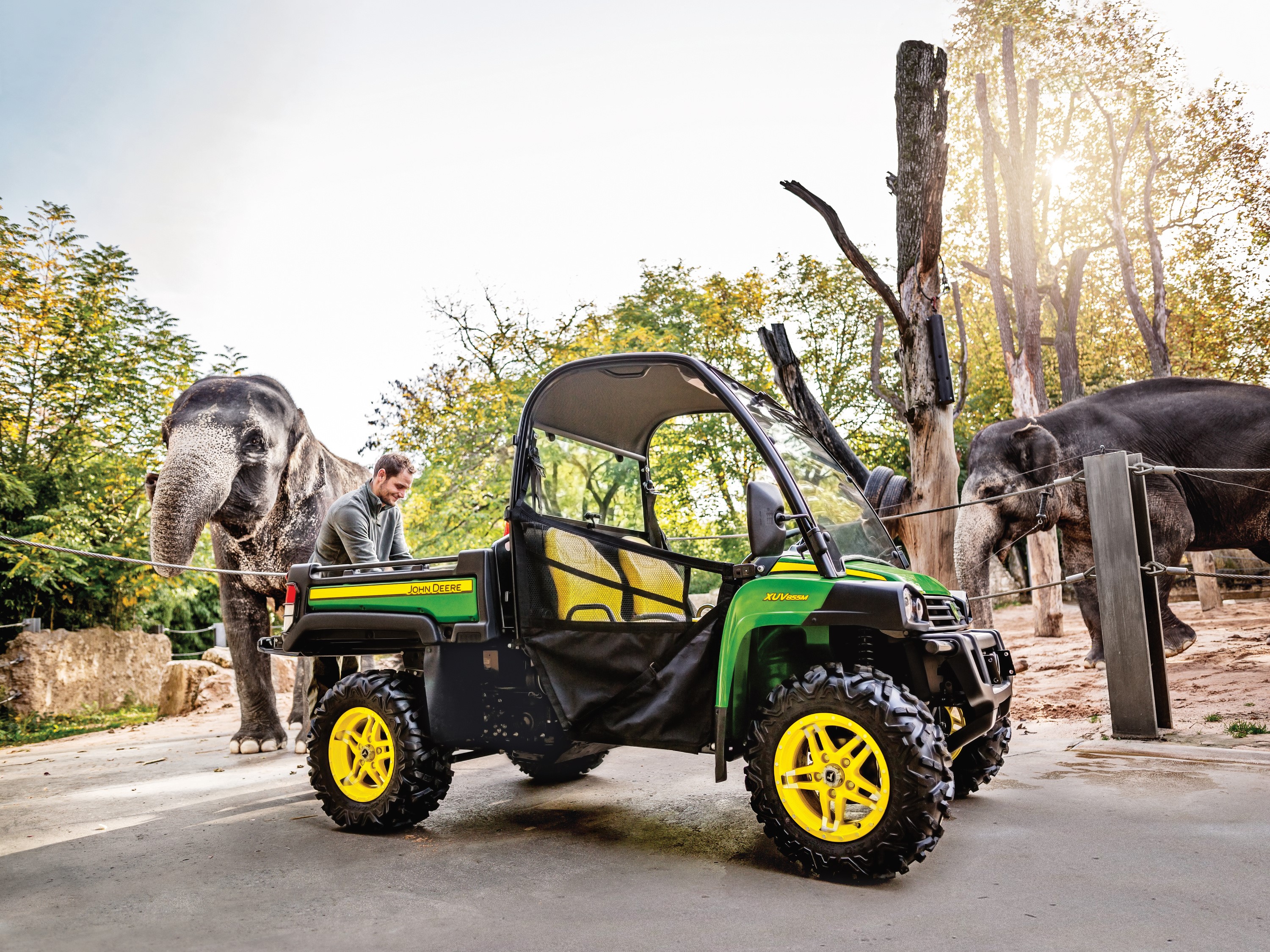 John Deere Gator XUV855M UTV with elephants at zoo HD Wallpaper
