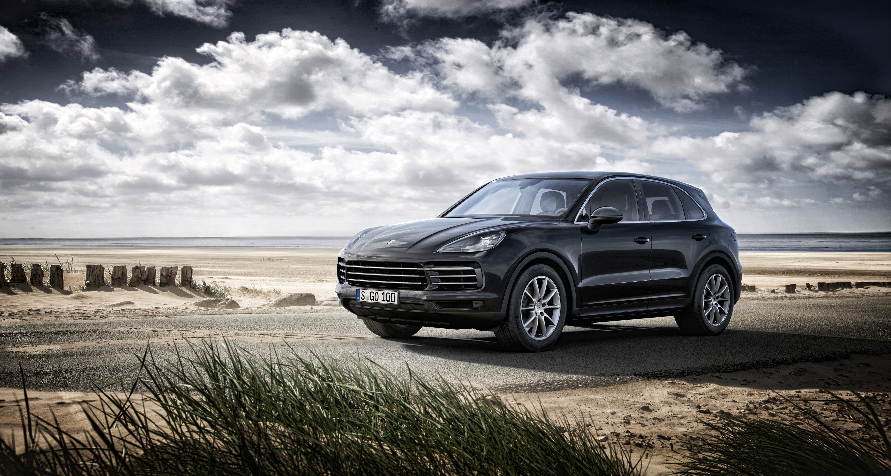 Black Porsche Cayenne on a beach road HD Wallpaper