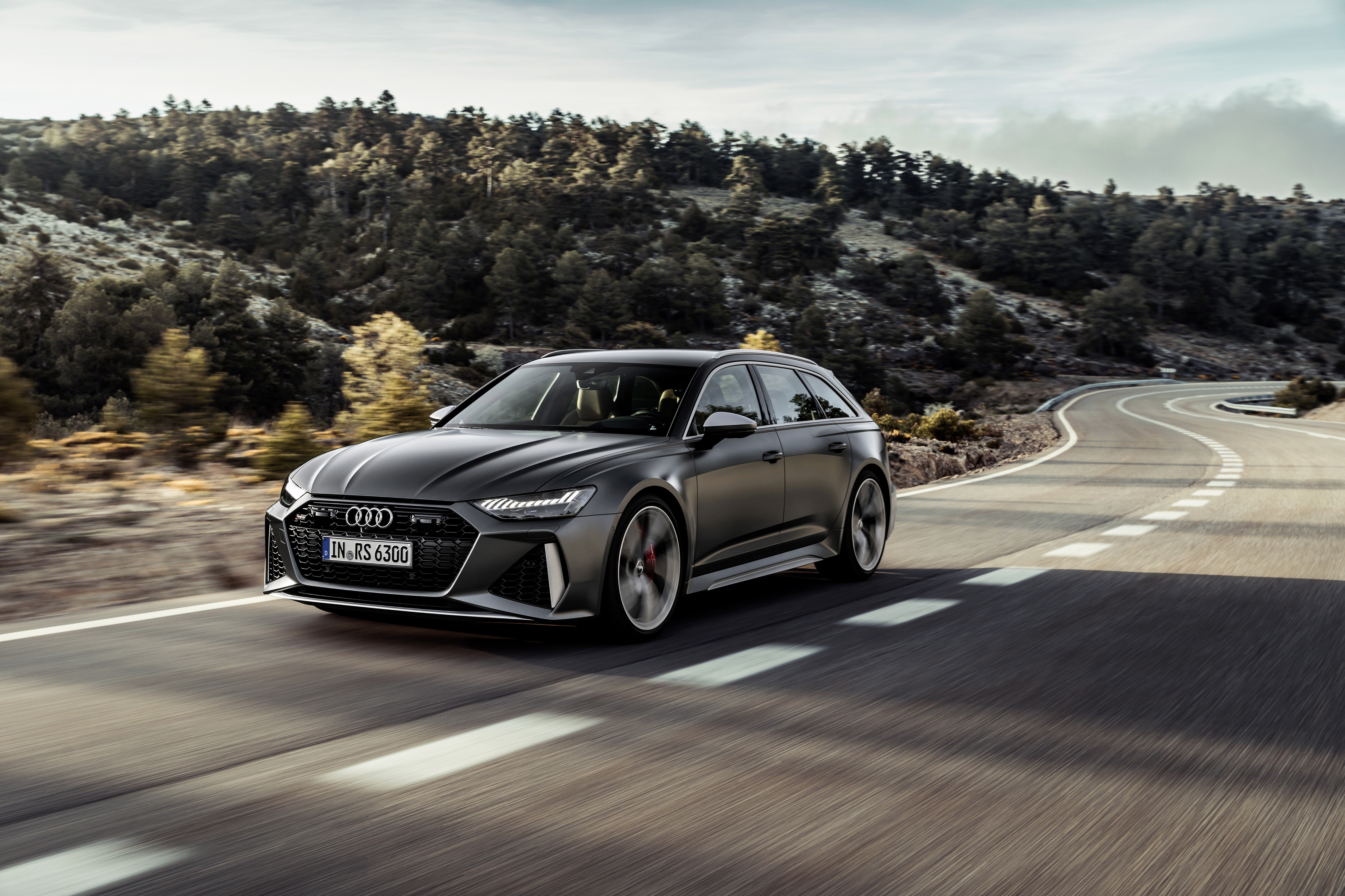 Audi RS 6 Avant driving on a winding road HD Wallpaper