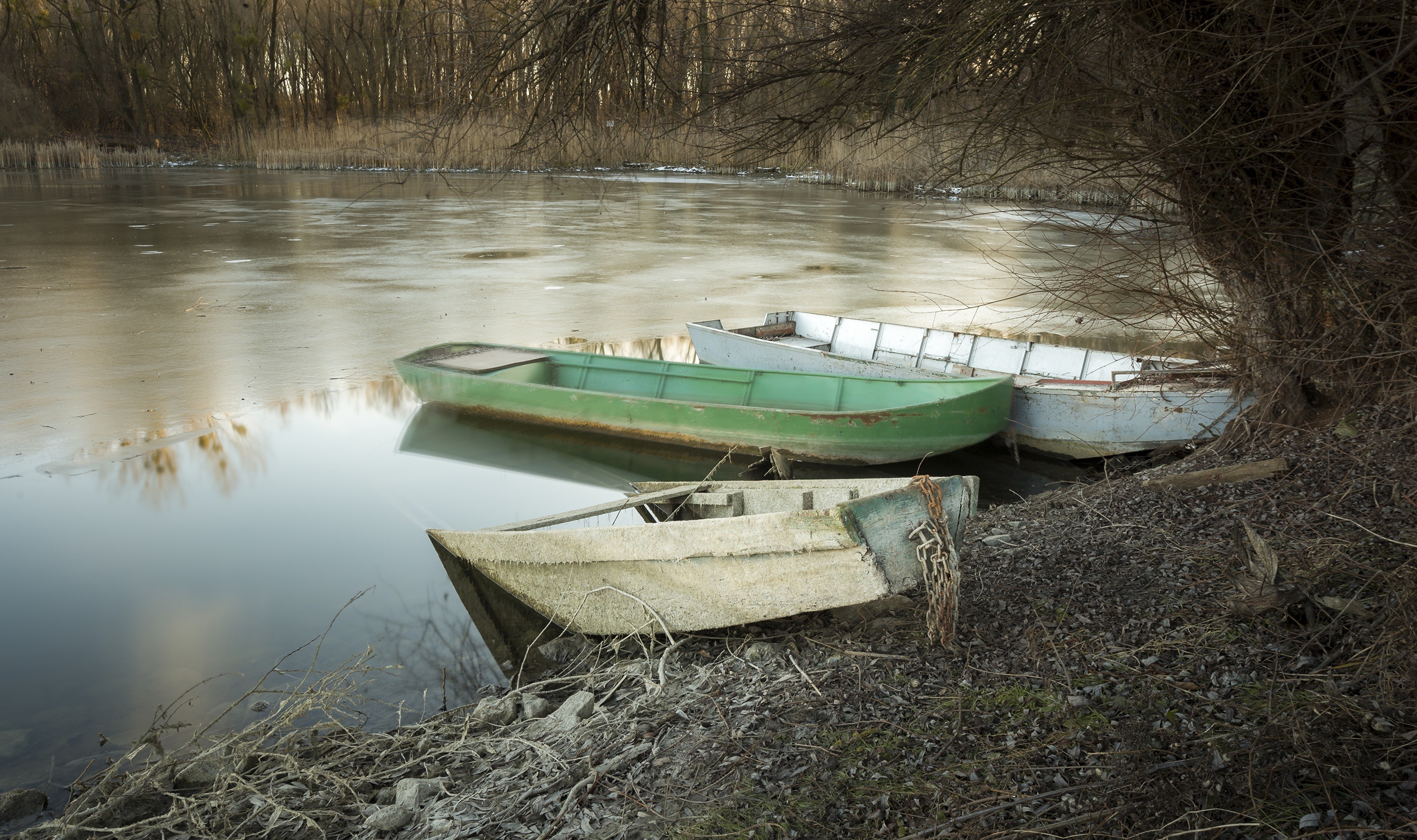 Boats on a partially frozen lake HD Wallpaper