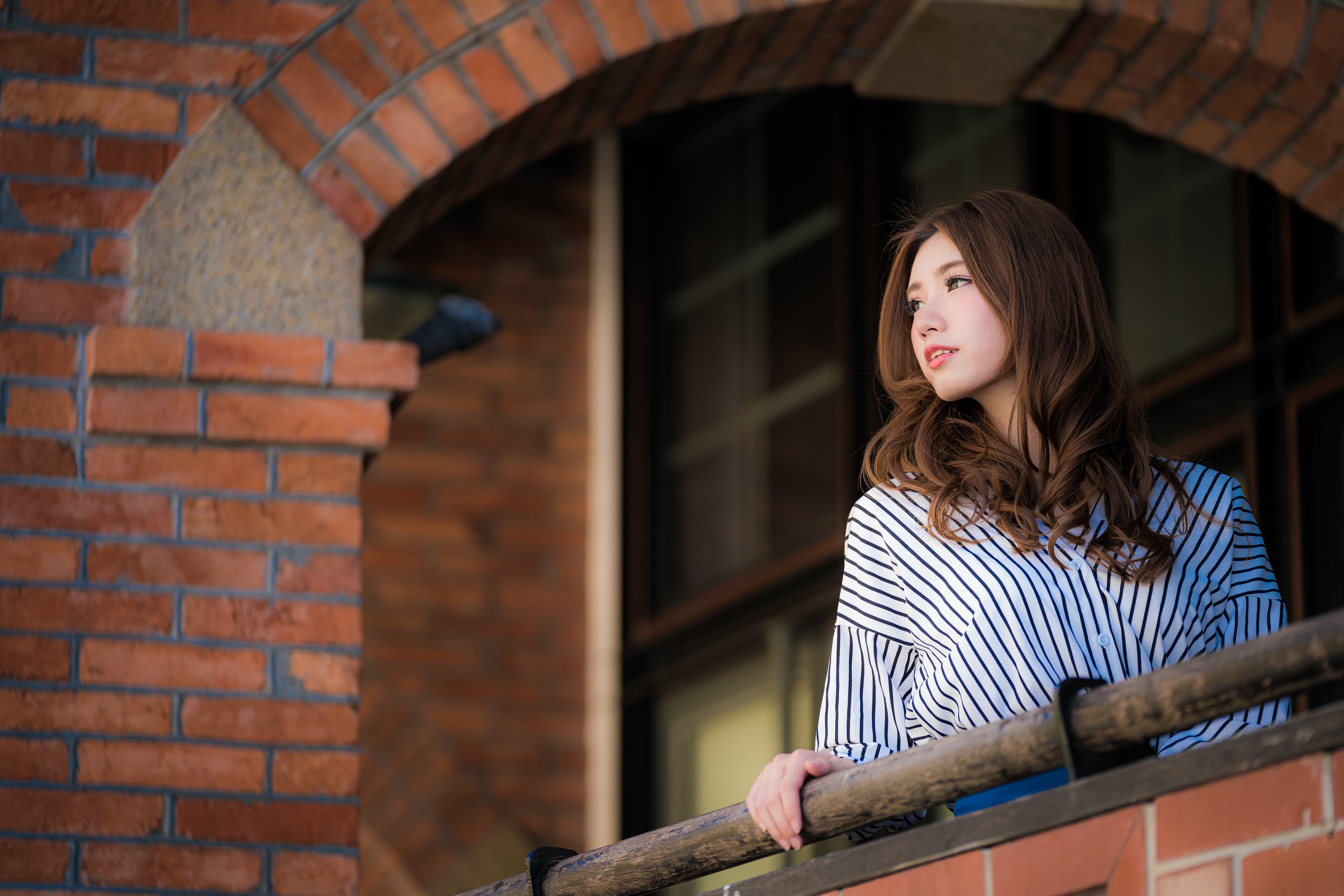 Asian woman with brown hair on a balcony HD Wallpaper