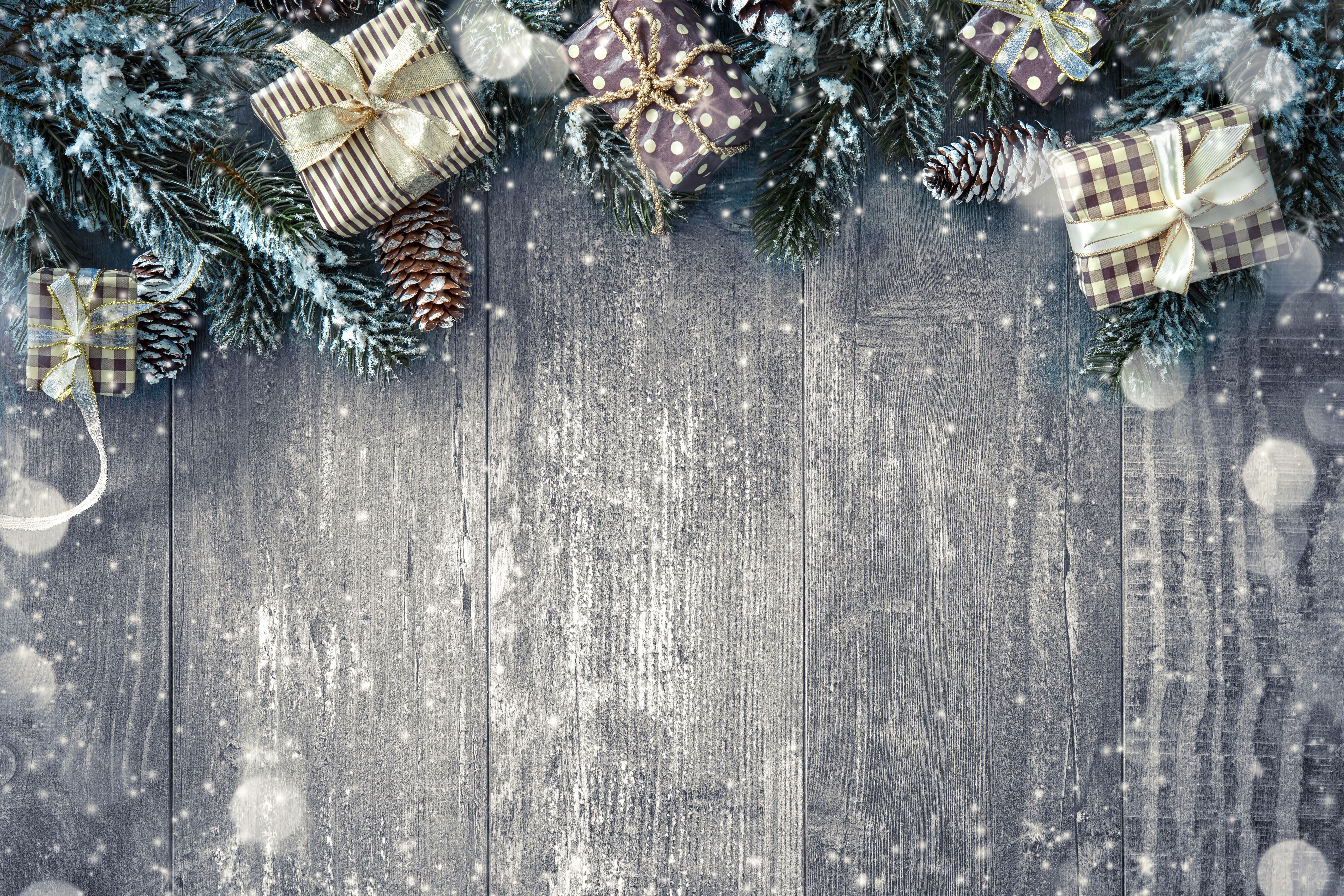 Christmas gifts and pine branches on wooden planks HD Wallpaper