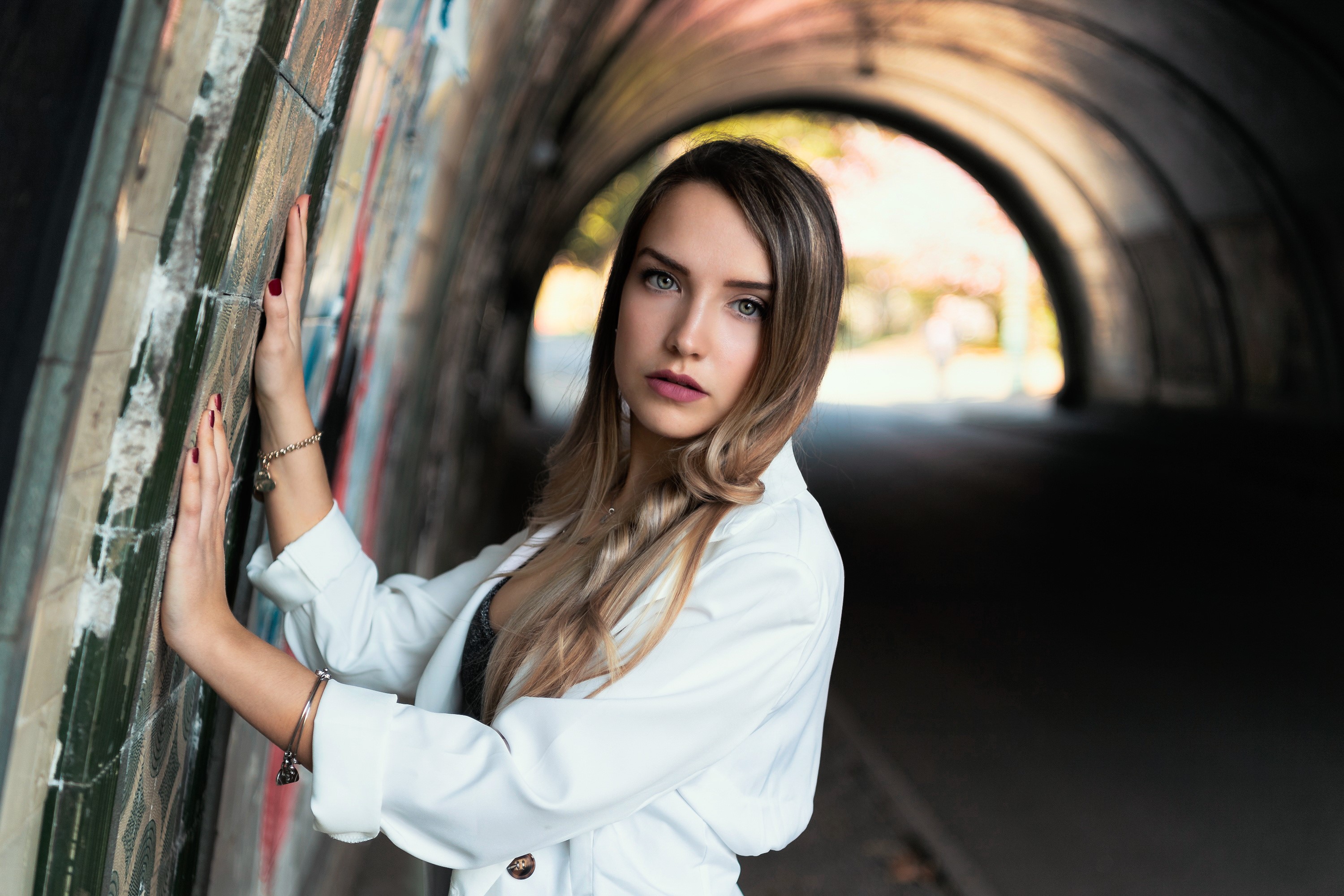 Woman in white jacket in graffiti tunnel HD Wallpaper