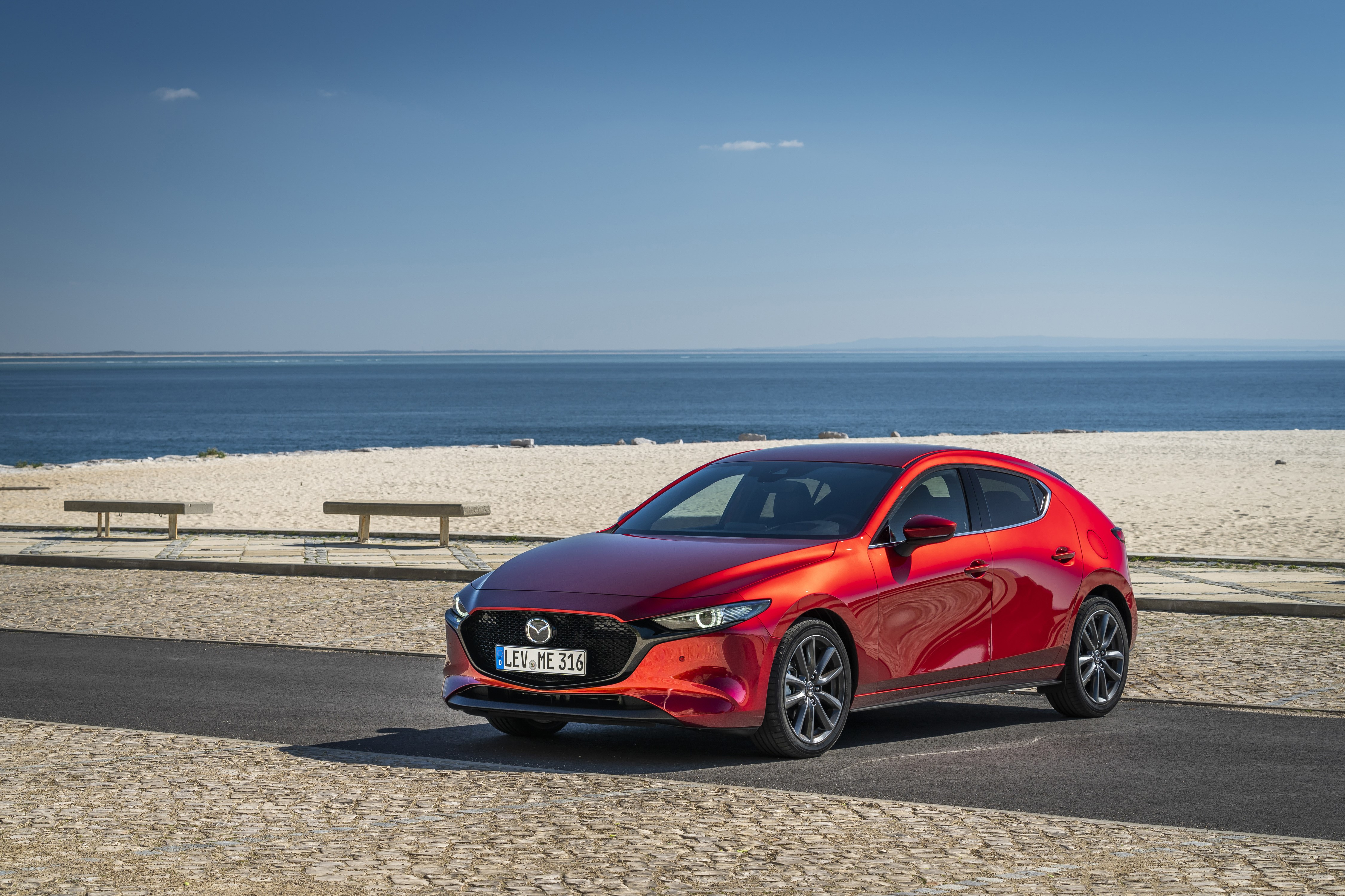 Red 2019 Mazda3 Skyactiv-G Hatchback by the sea HD Wallpaper