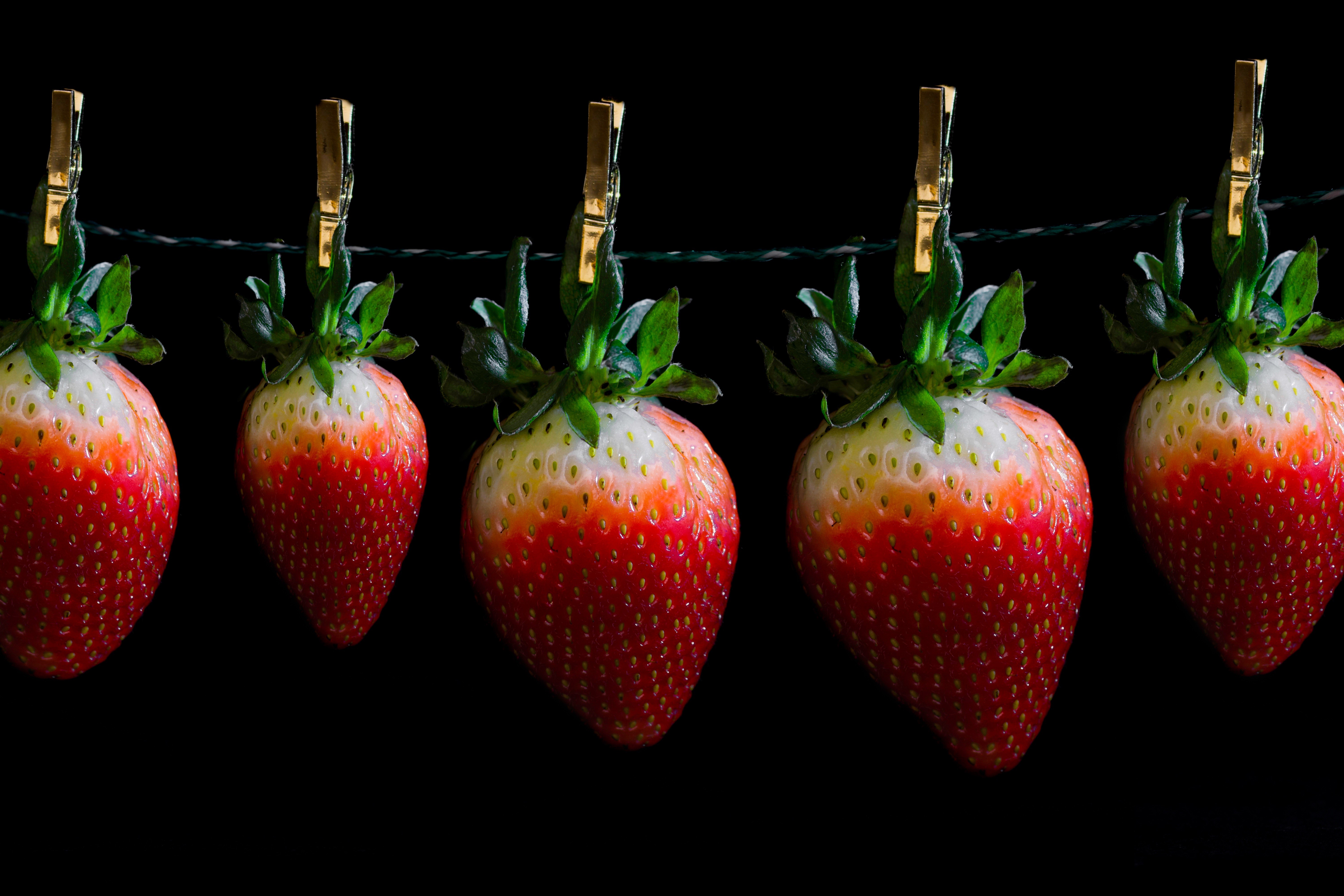 Five Strawberries Hanging on a Line with Clothespins HD Wallpaper