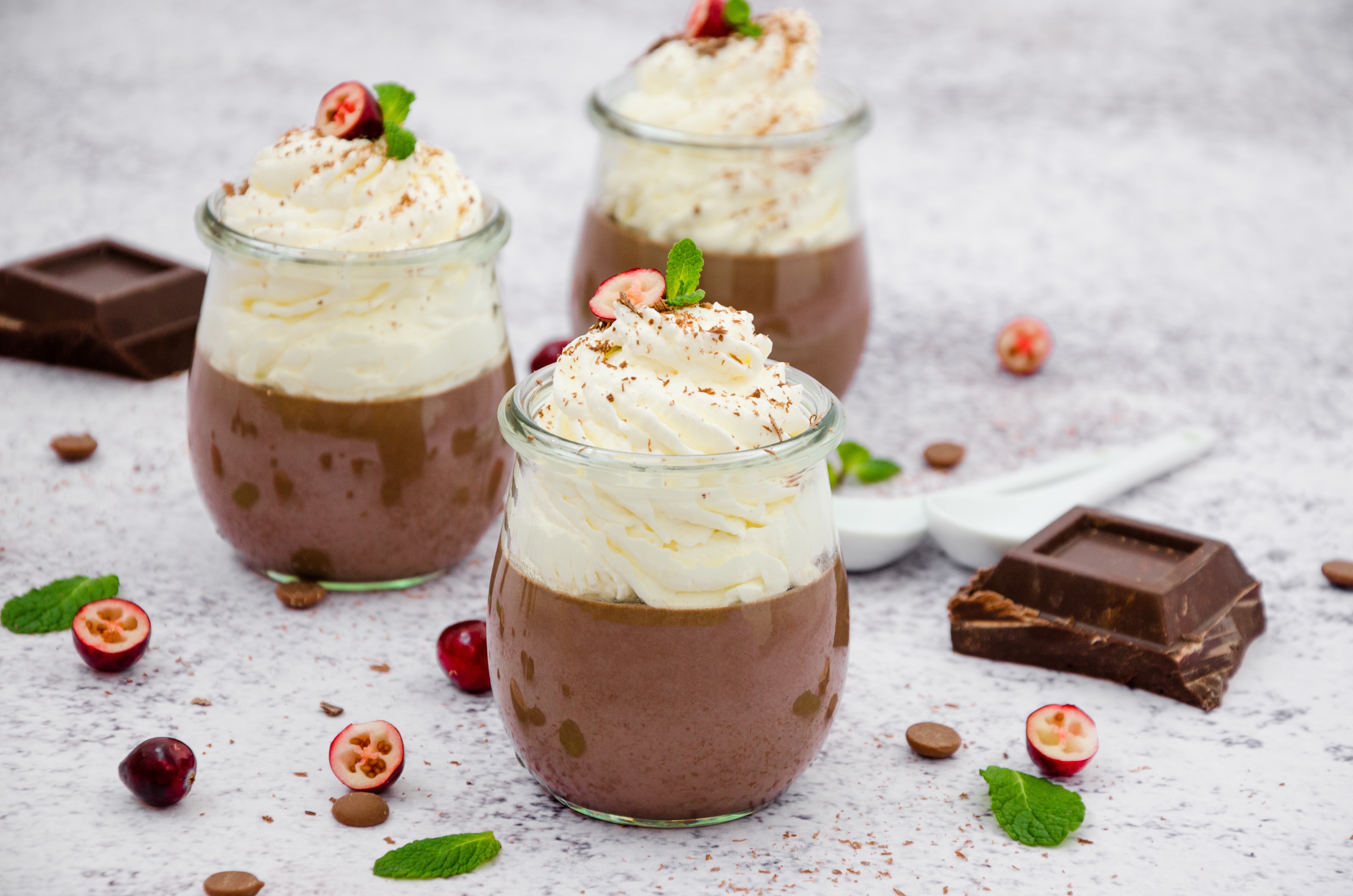 Chocolate dessert in jars with whipped cream and cranberries HD Wallpaper