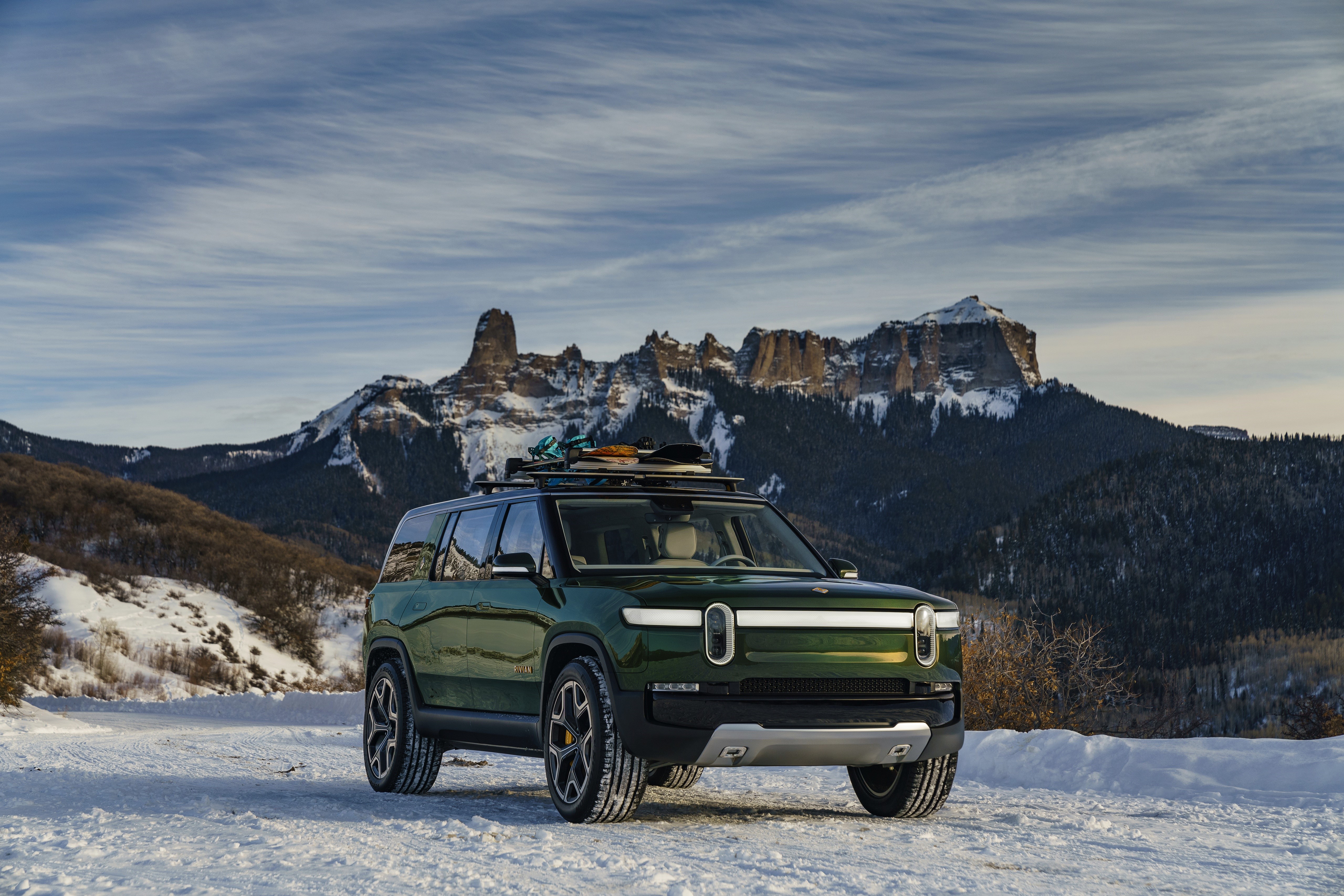 2019 Rivian R1S SUV in snowy mountains HD Wallpaper