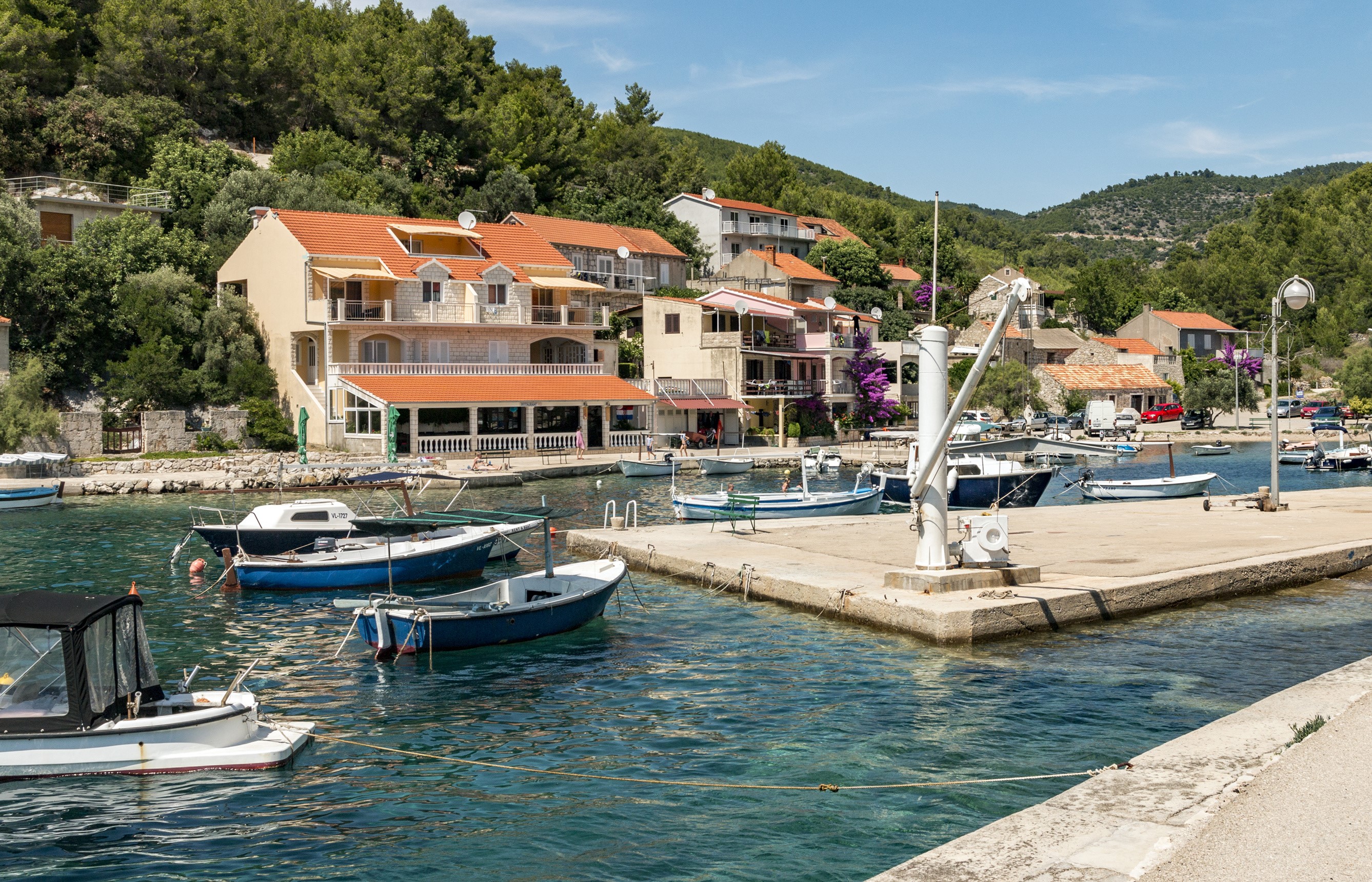 Boats docked in a bay with houses in Croatia HD Wallpaper