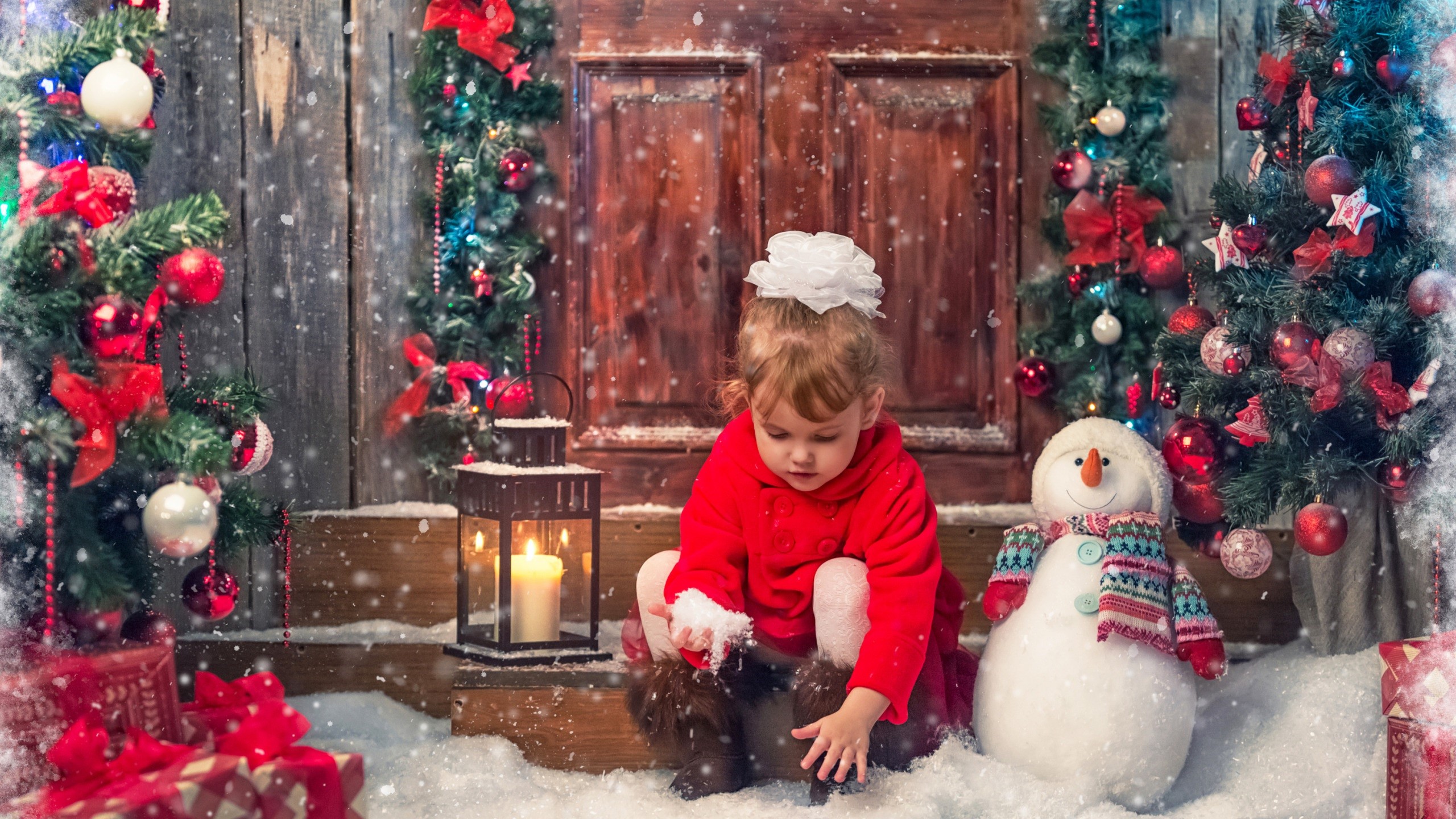 Little girl playing in the snow with Christmas decorations HD Wallpaper