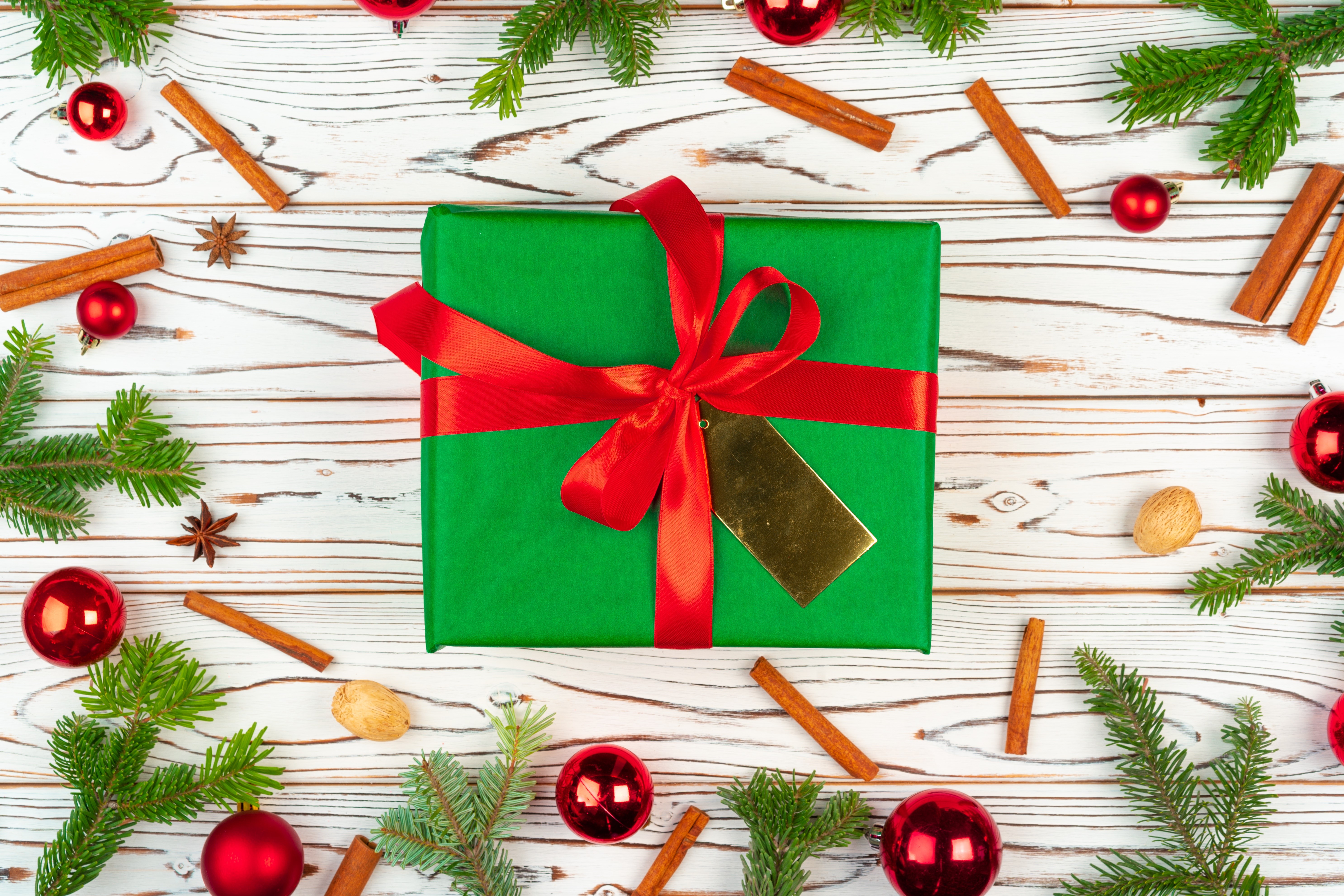 Christmas gift with red ribbon and ornaments HD Wallpaper
