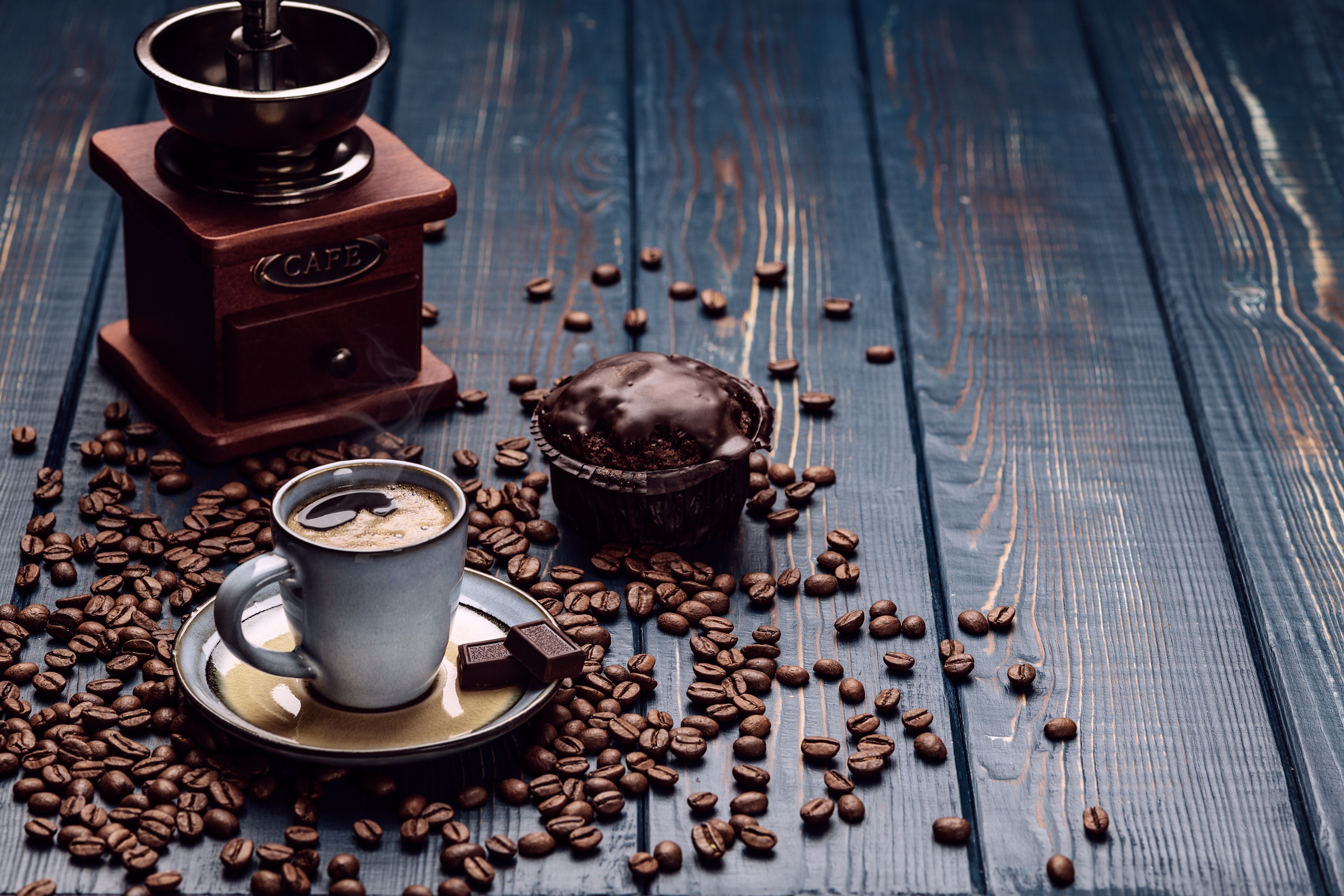 Coffee cup, muffin, and coffee grinder on wood planks HD Wallpaper