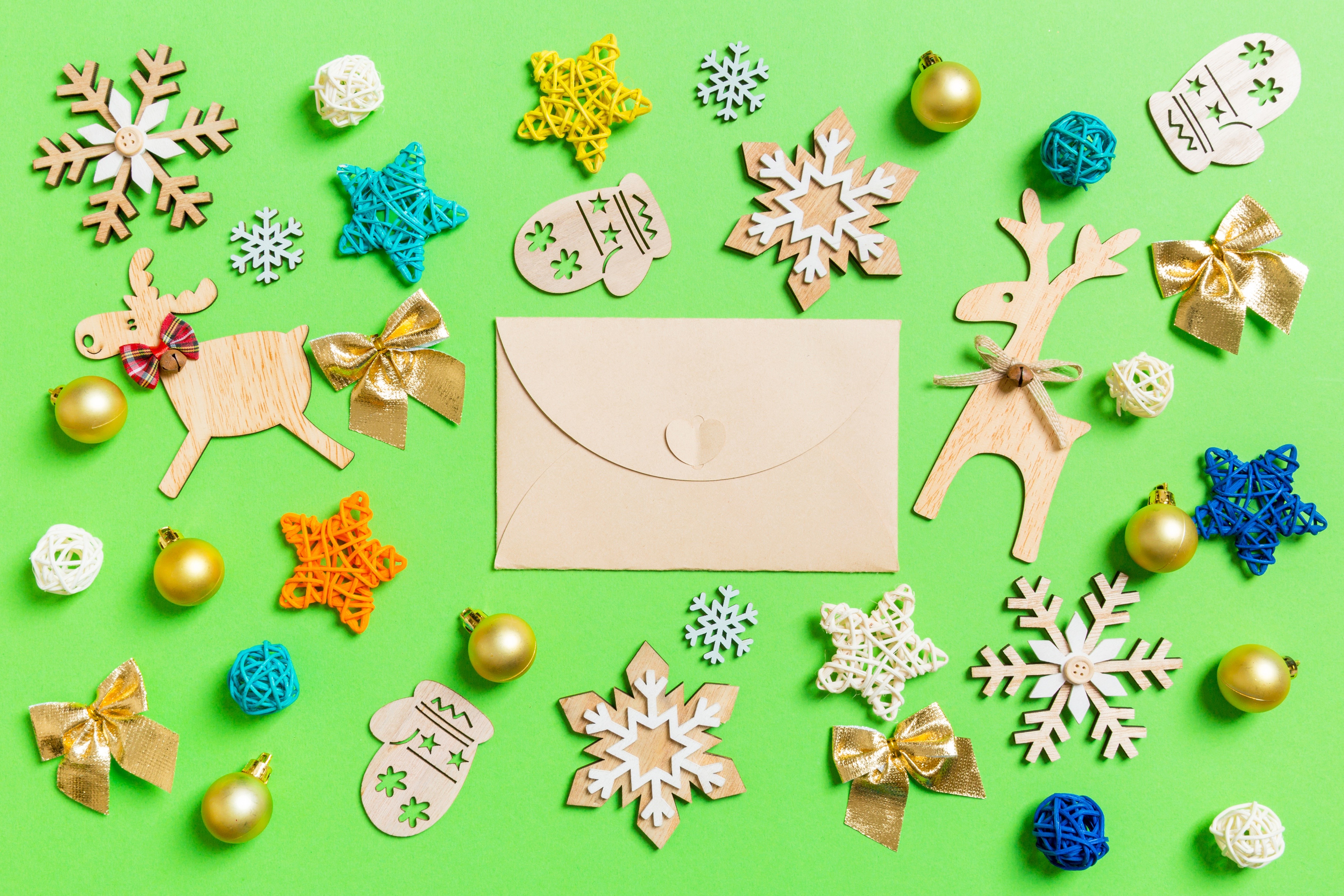 Christmas decorations and envelope on green background HD Wallpaper