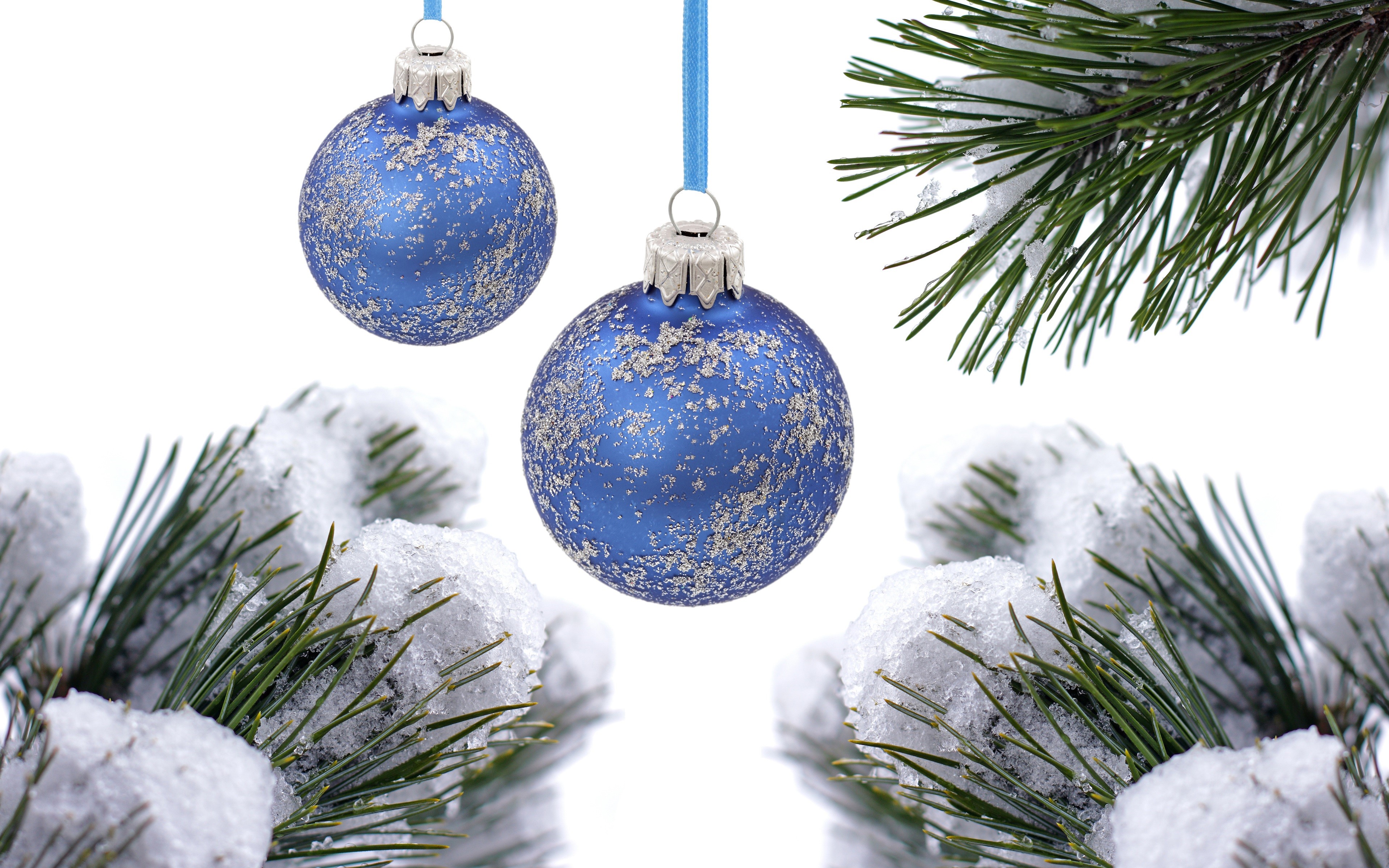 Two blue Christmas ornaments with snow on pine branches HD Wallpaper