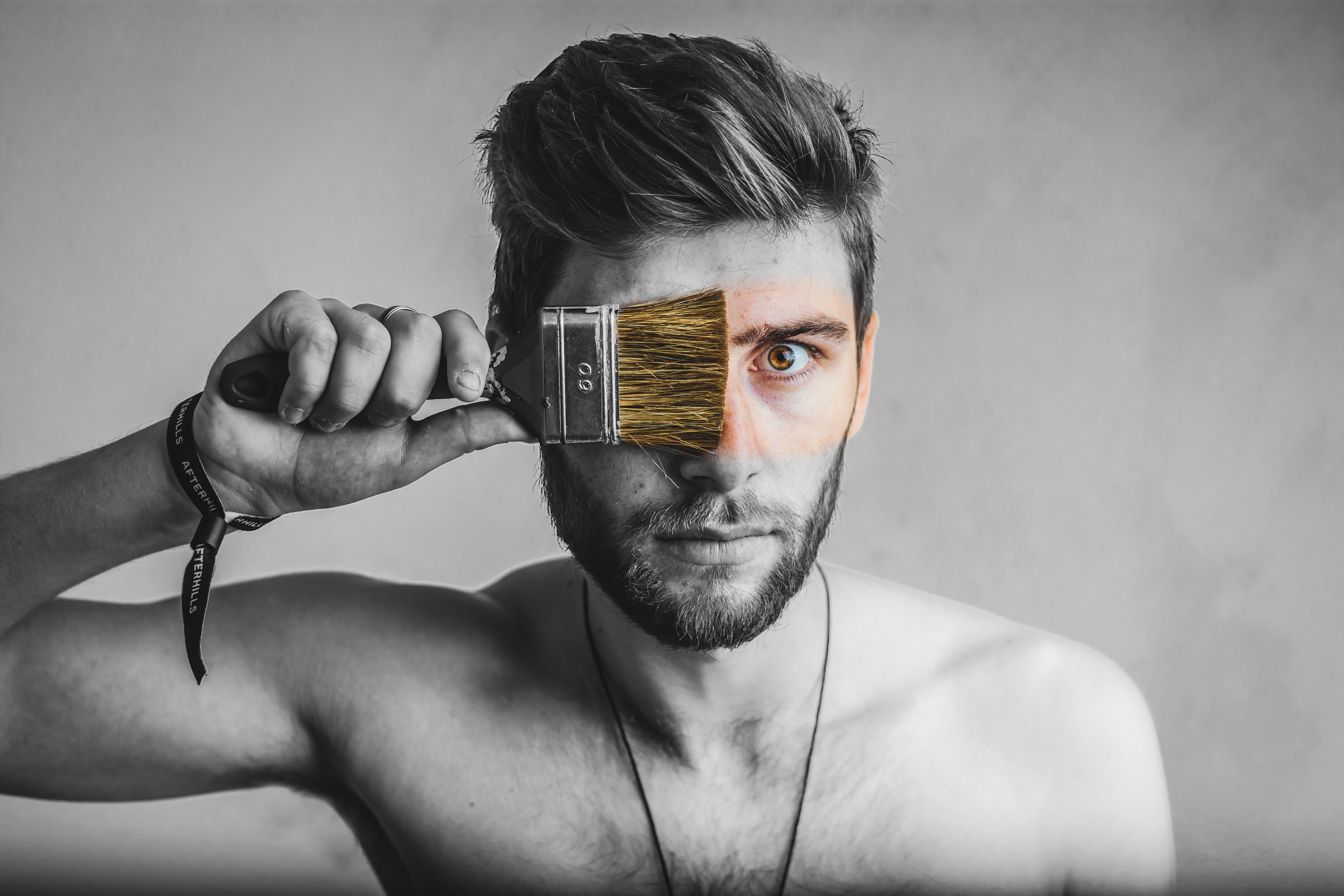 Man holding paintbrush over eye HD Wallpaper