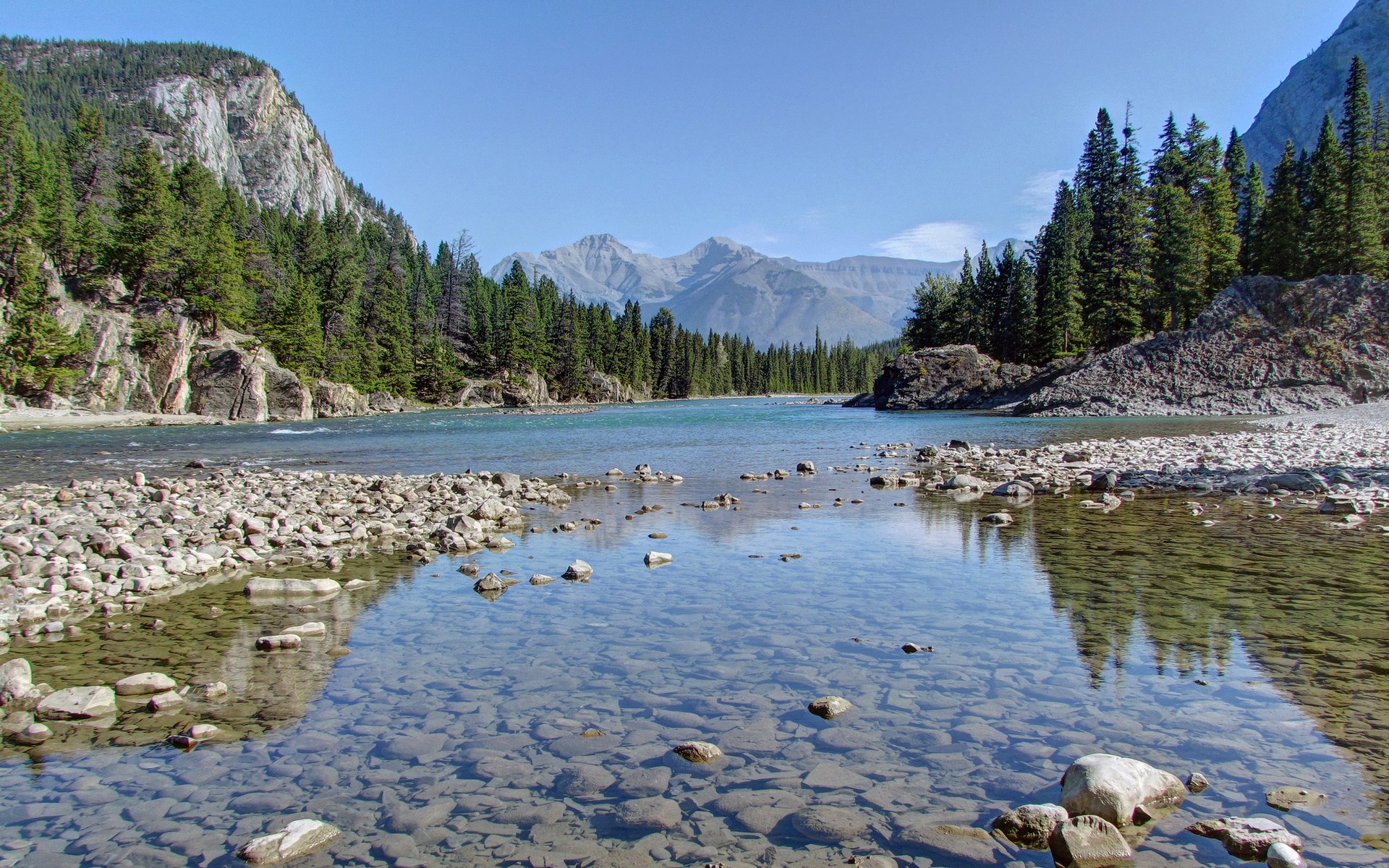 River flowing through a rocky, forested mountain landscape HD Wallpaper