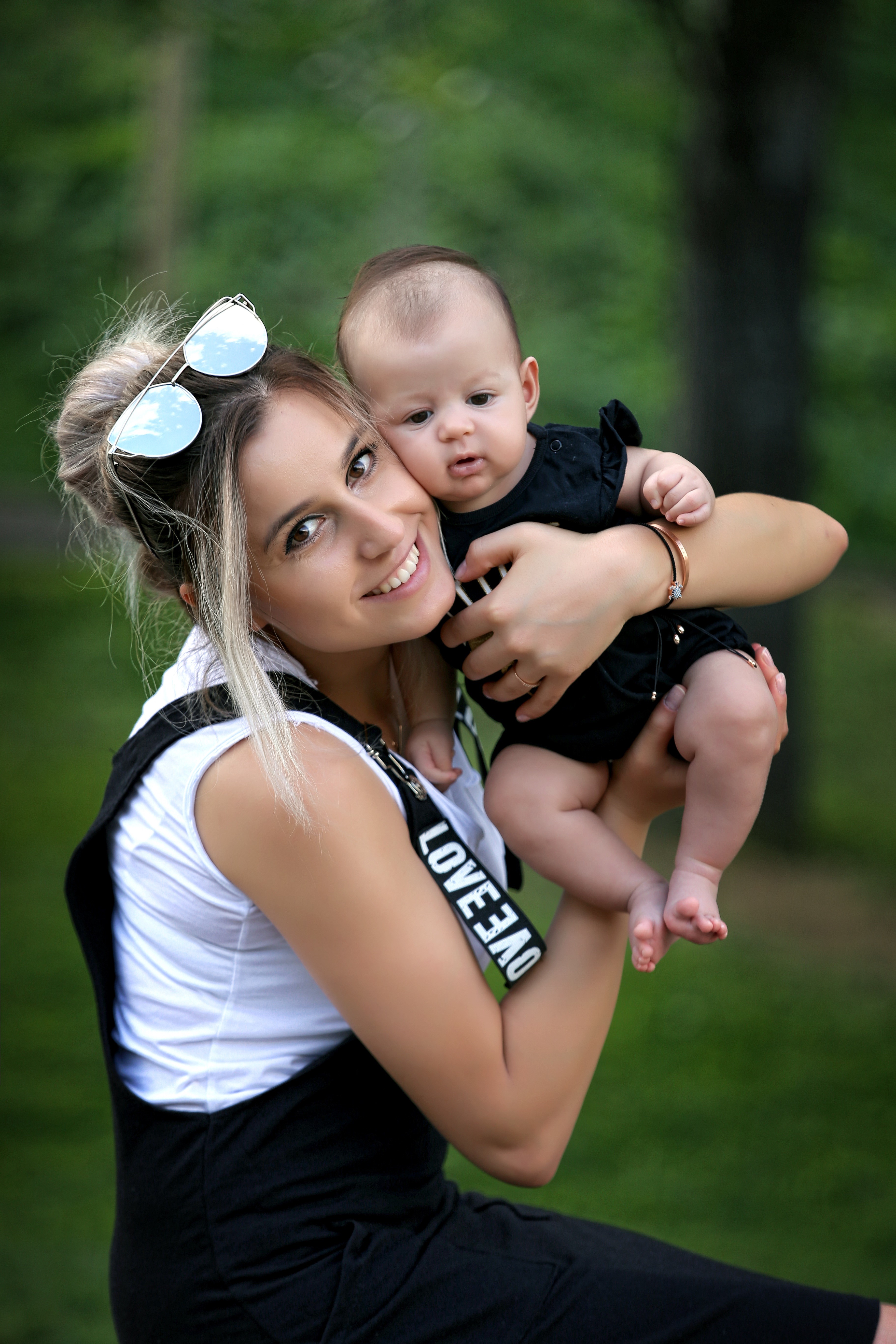 Mother holding her baby outdoors HD Phone Wallpaper