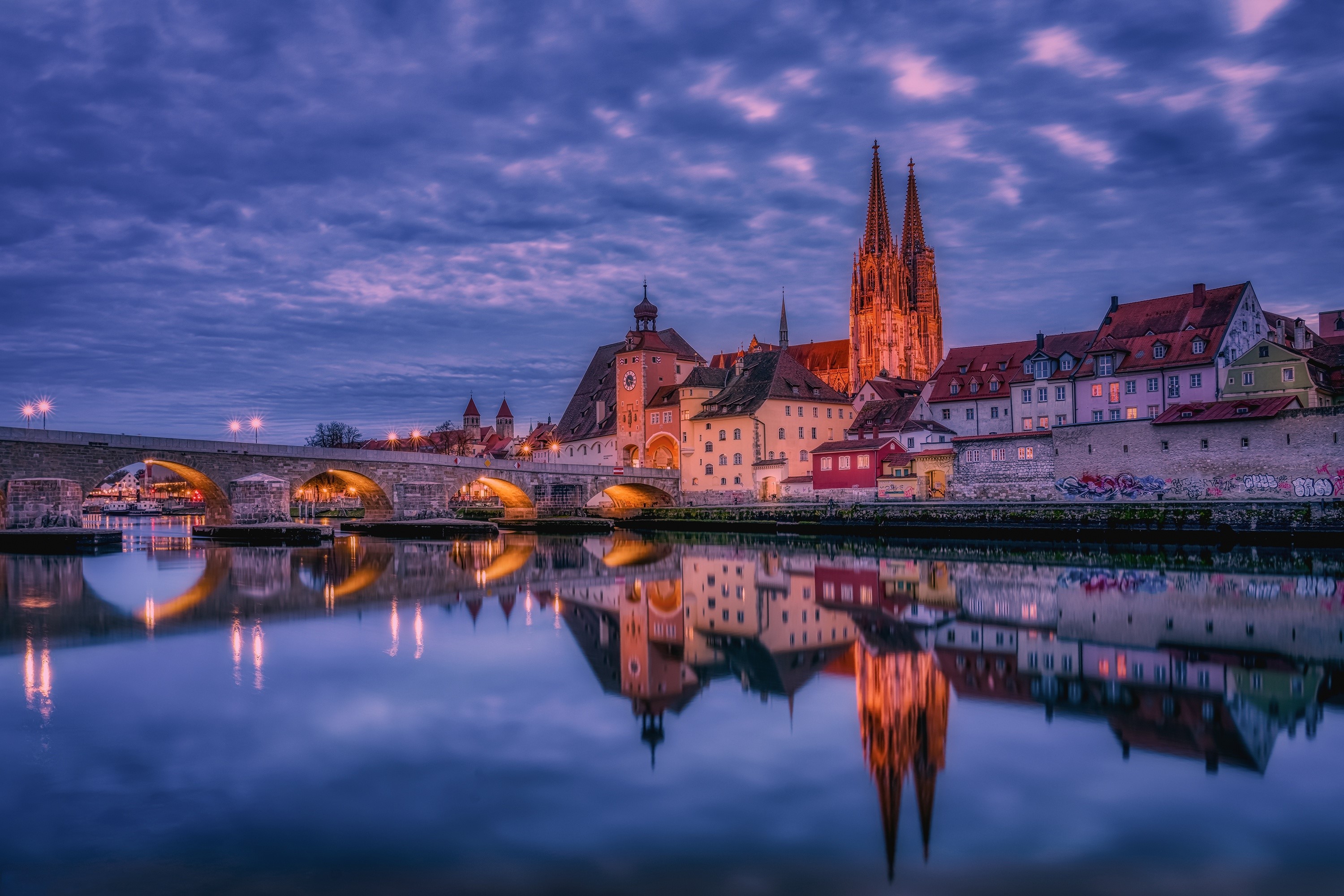 Regensburg skyline with bridge and river at dusk HD Wallpaper