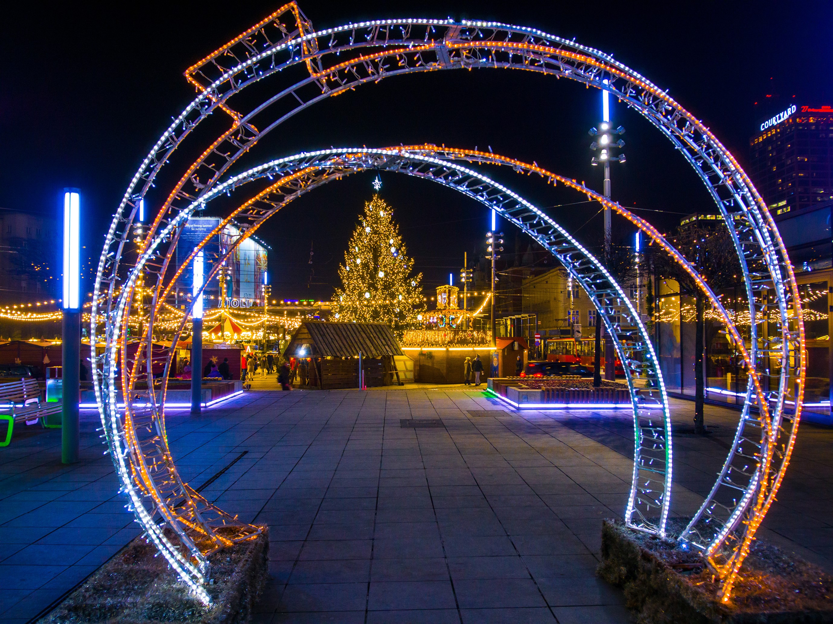 Christmas market with illuminated archway and tree in Katowice, Poland HD Wallpaper