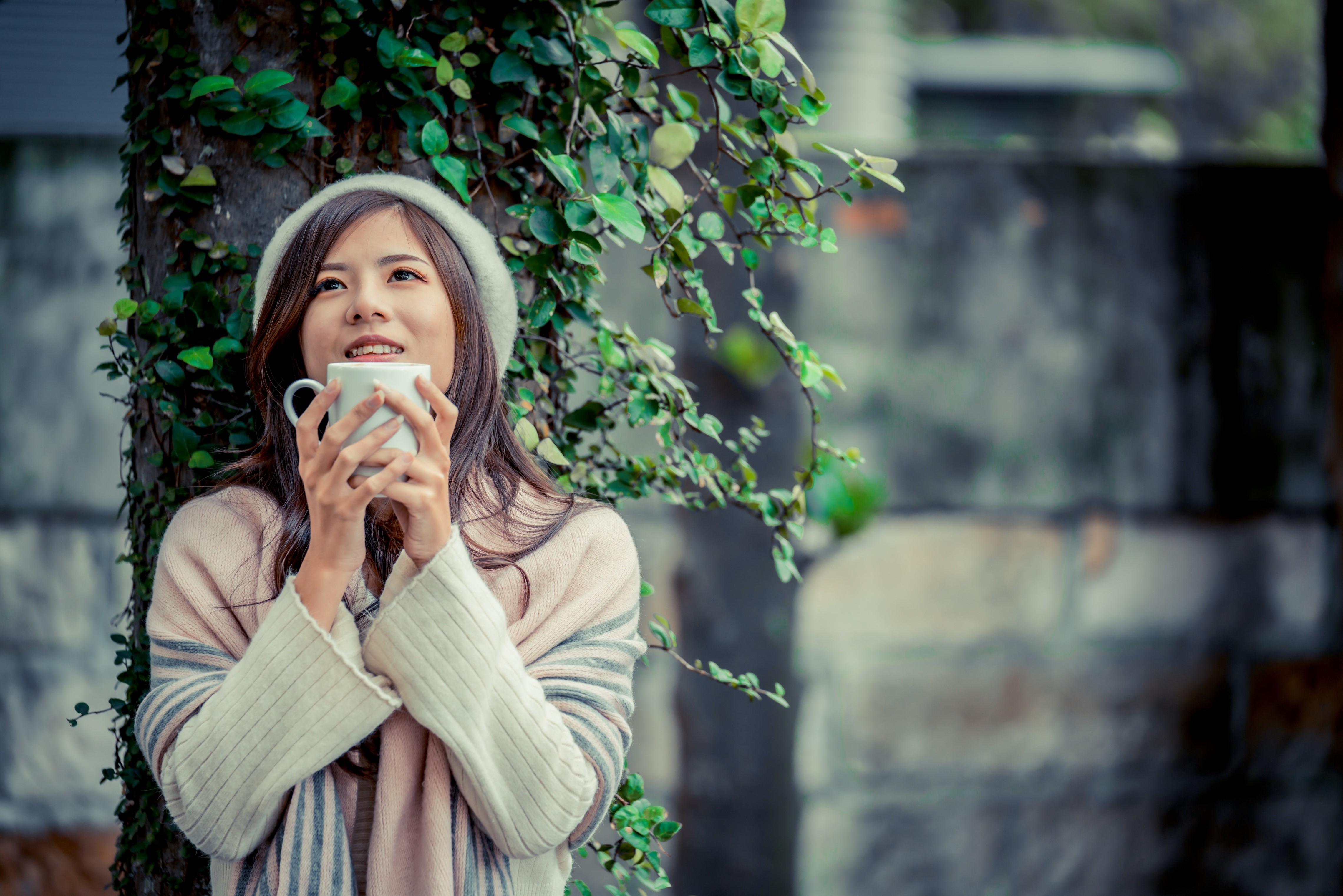 Asian woman holding a mug with ivy background HD Wallpaper