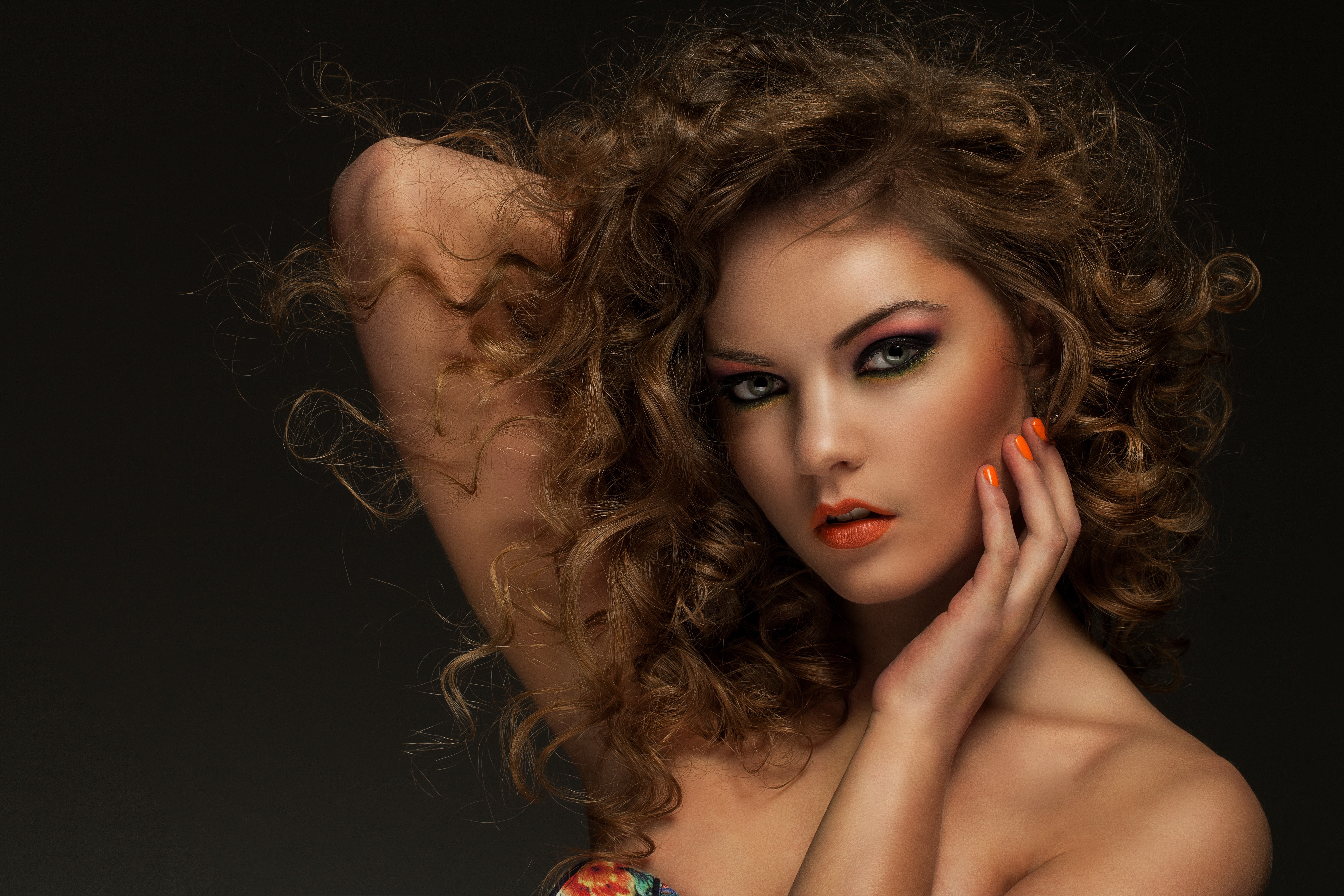 Beautiful woman with curly brown hair and vibrant makeup HD Wallpaper