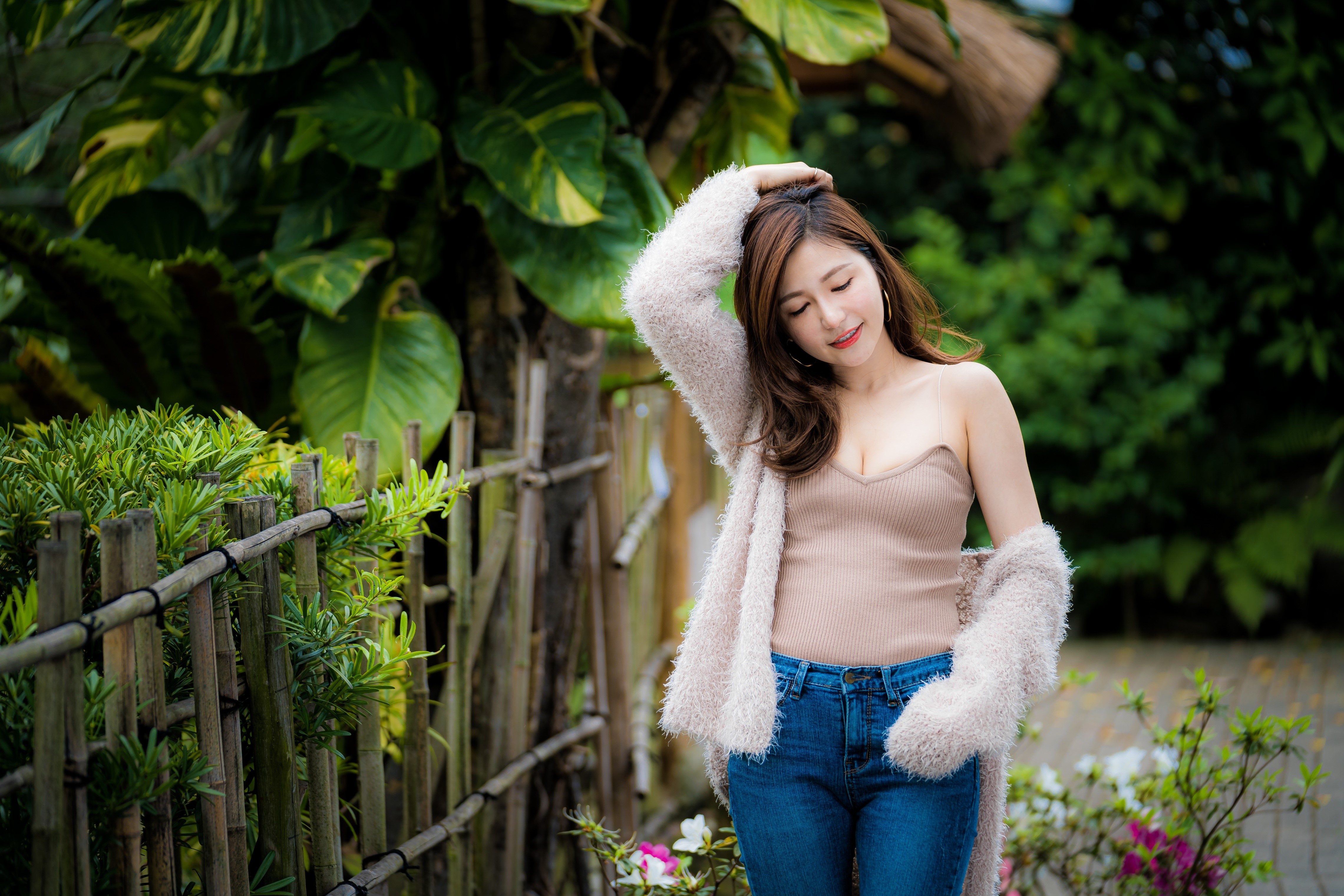 Asian woman in jeans and singlet with fluffy cardigan HD Wallpaper