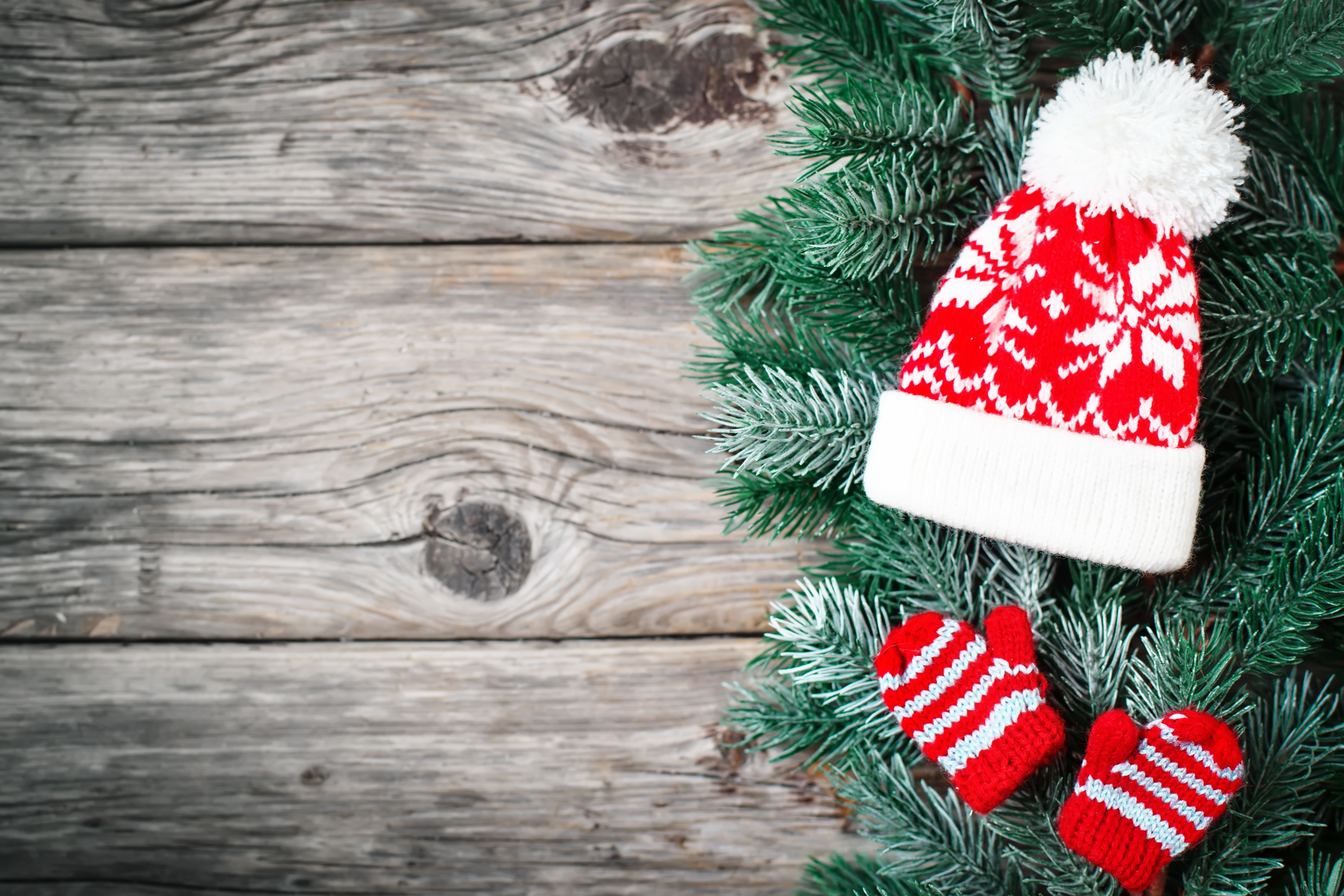 Christmas hat and mittens on wood planks HD Wallpaper