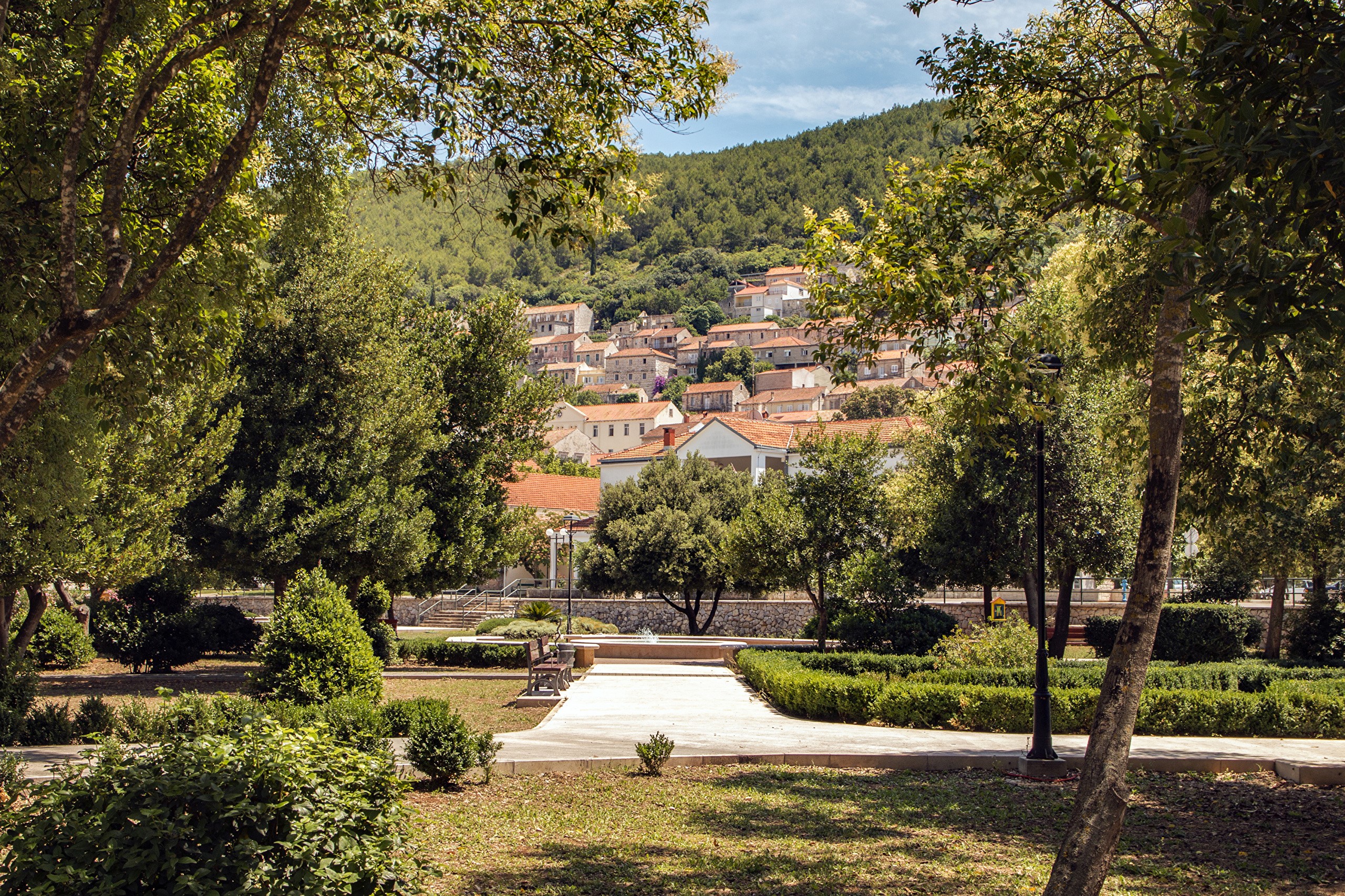 Park with houses on a hill in Croatia HD Wallpaper