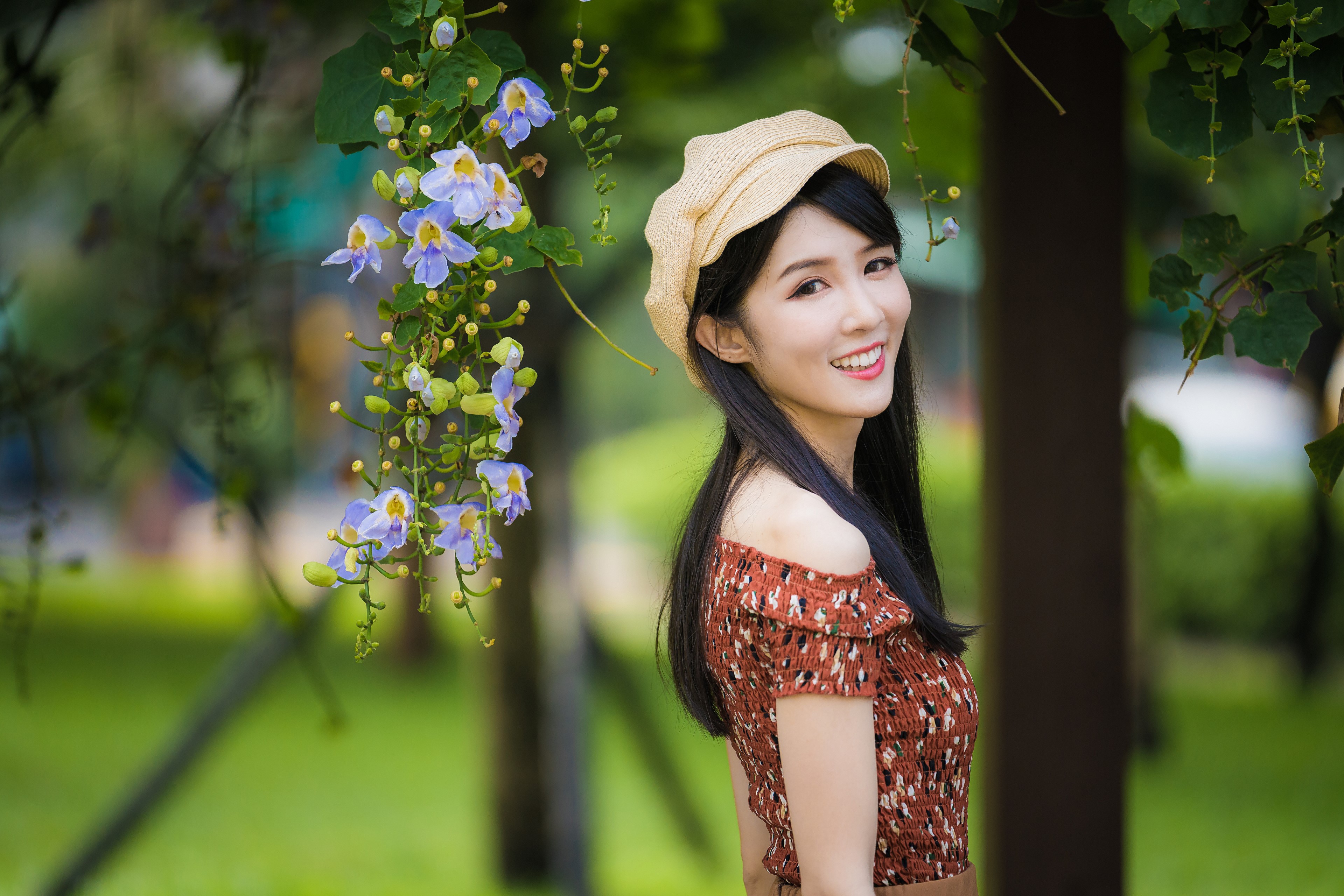 Asian woman with flowers and bokeh HD Wallpaper