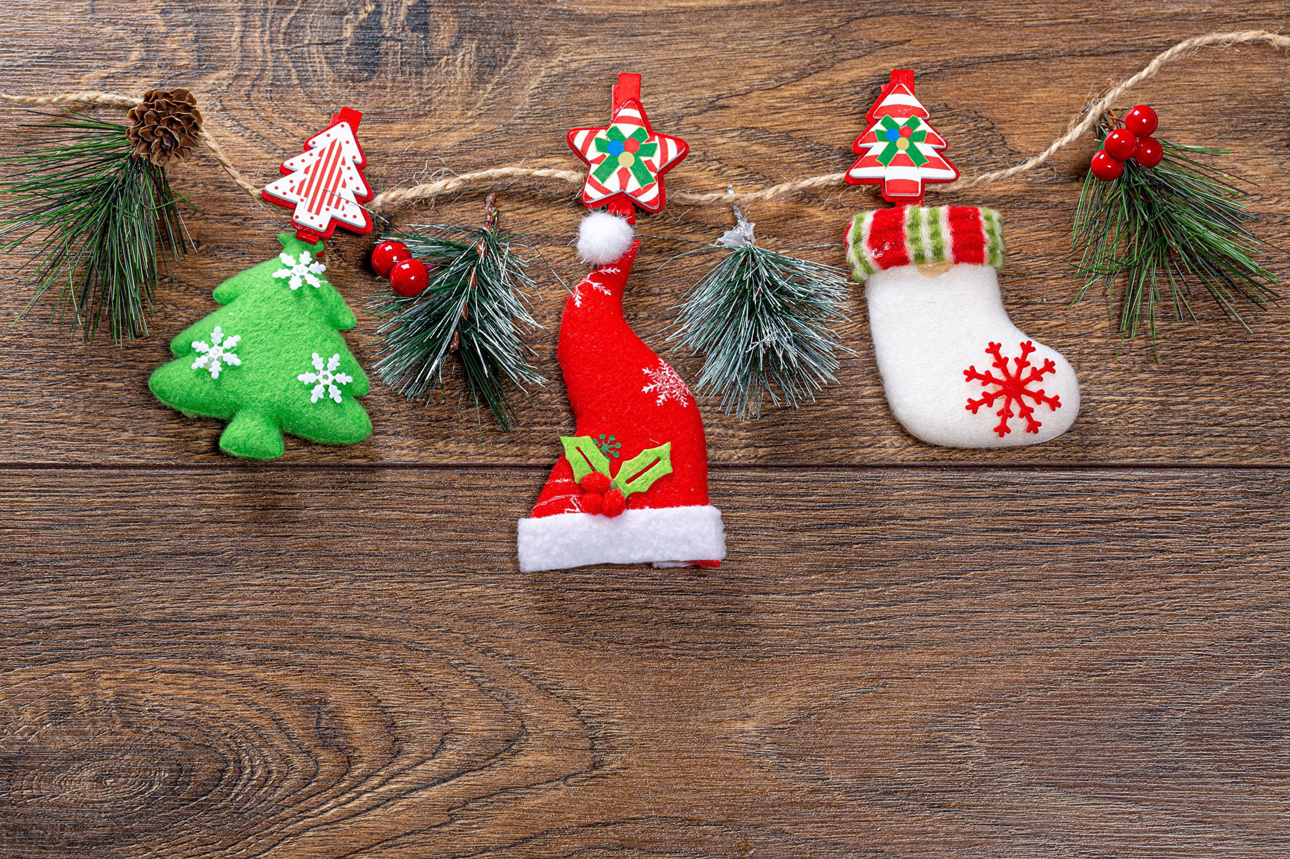 Christmas ornaments hanging on a wooden background HD Wallpaper
