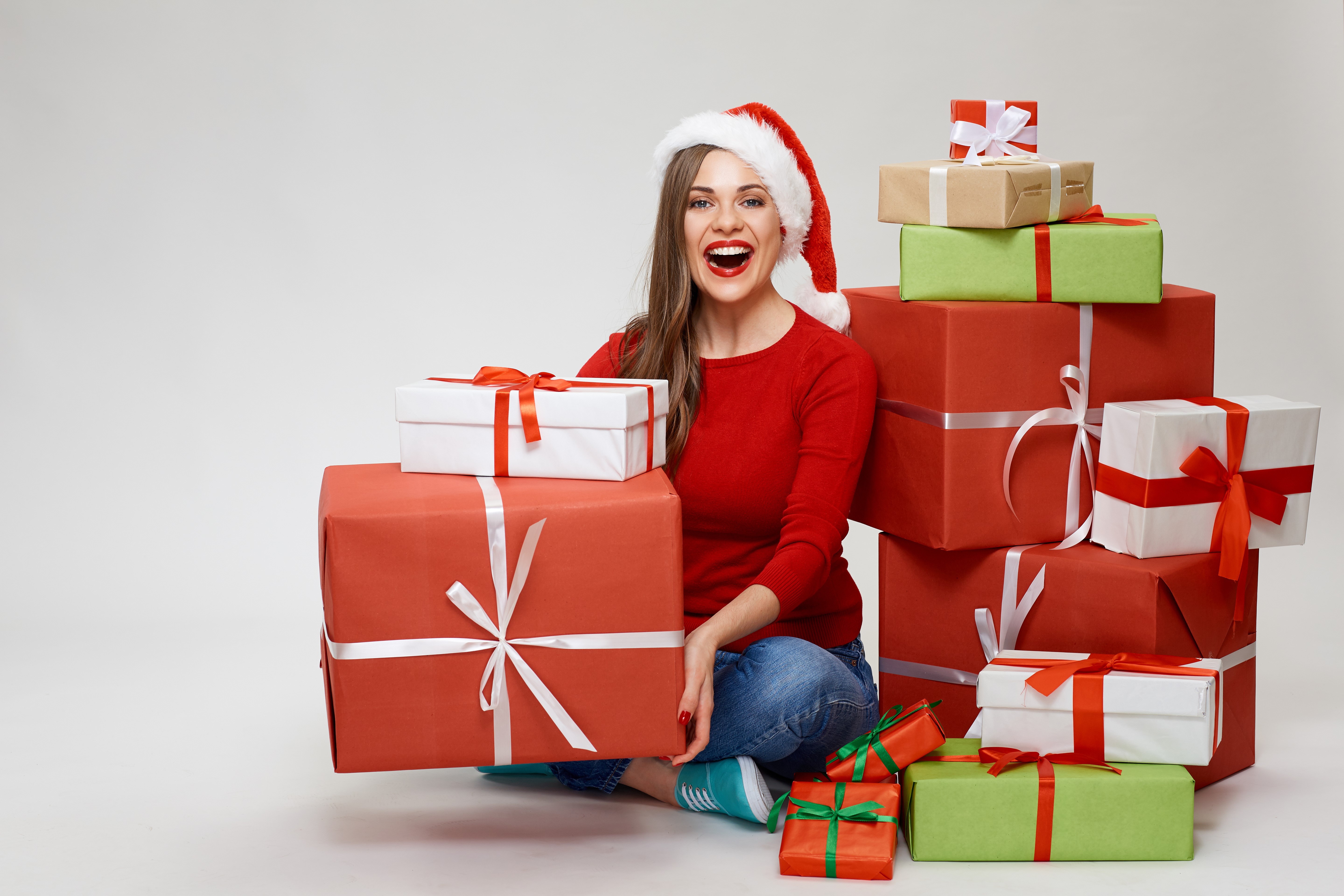 Woman in Santa hat with Christmas gifts HD Wallpaper