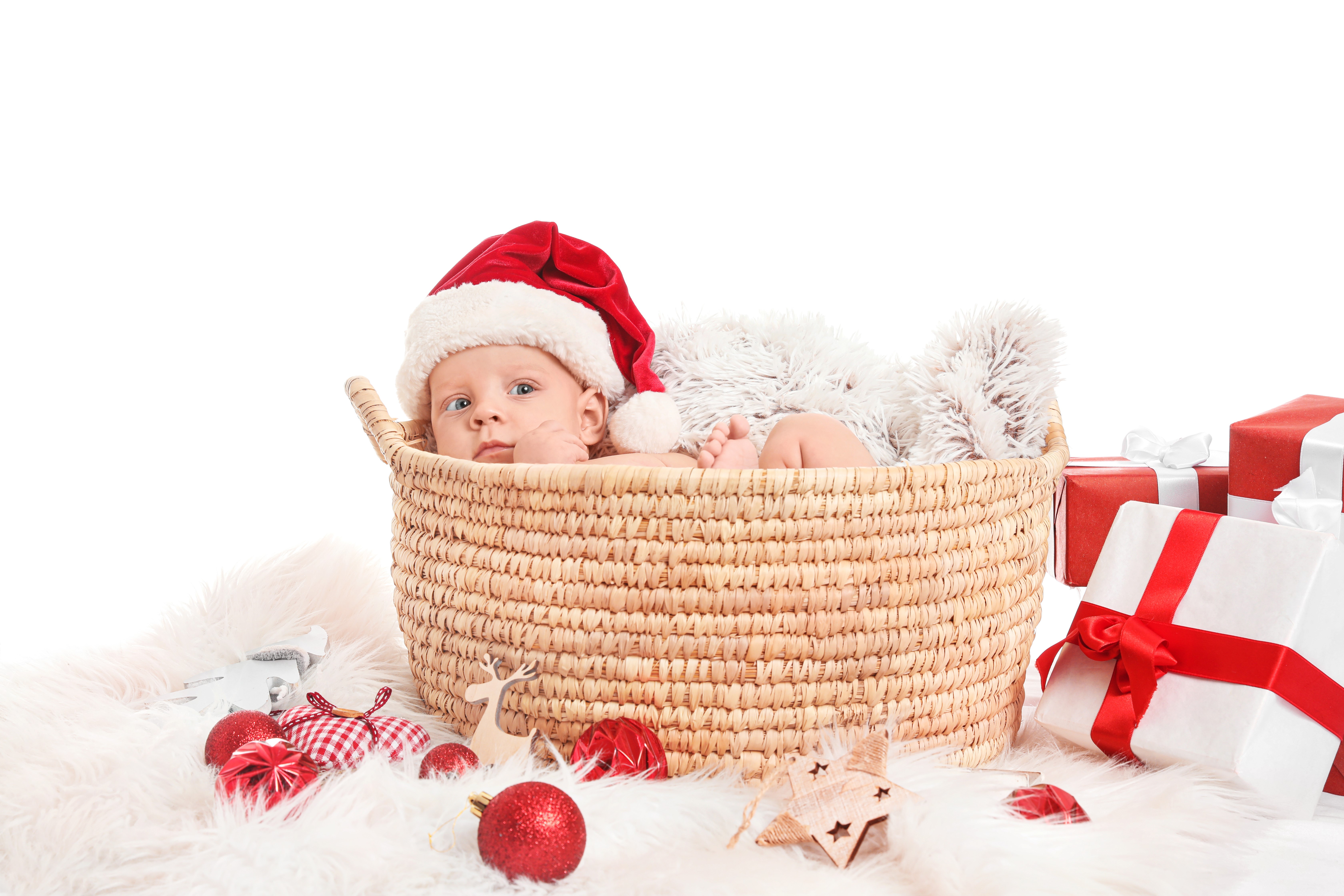 Baby in Santa hat in wicker basket with Christmas gifts HD Wallpaper
