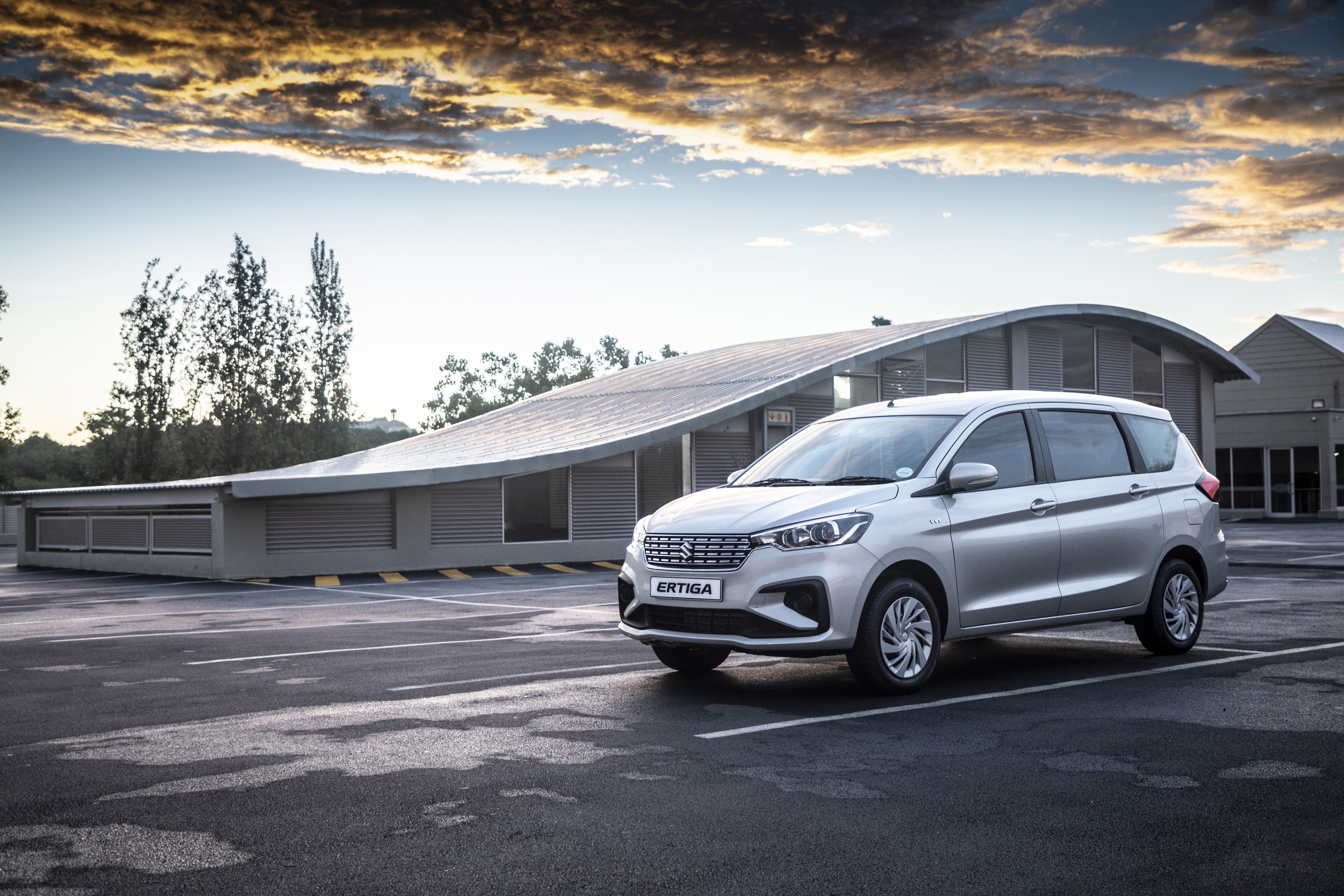 Silver Suzuki Ertiga GL minivan parked in a lot HD Wallpaper