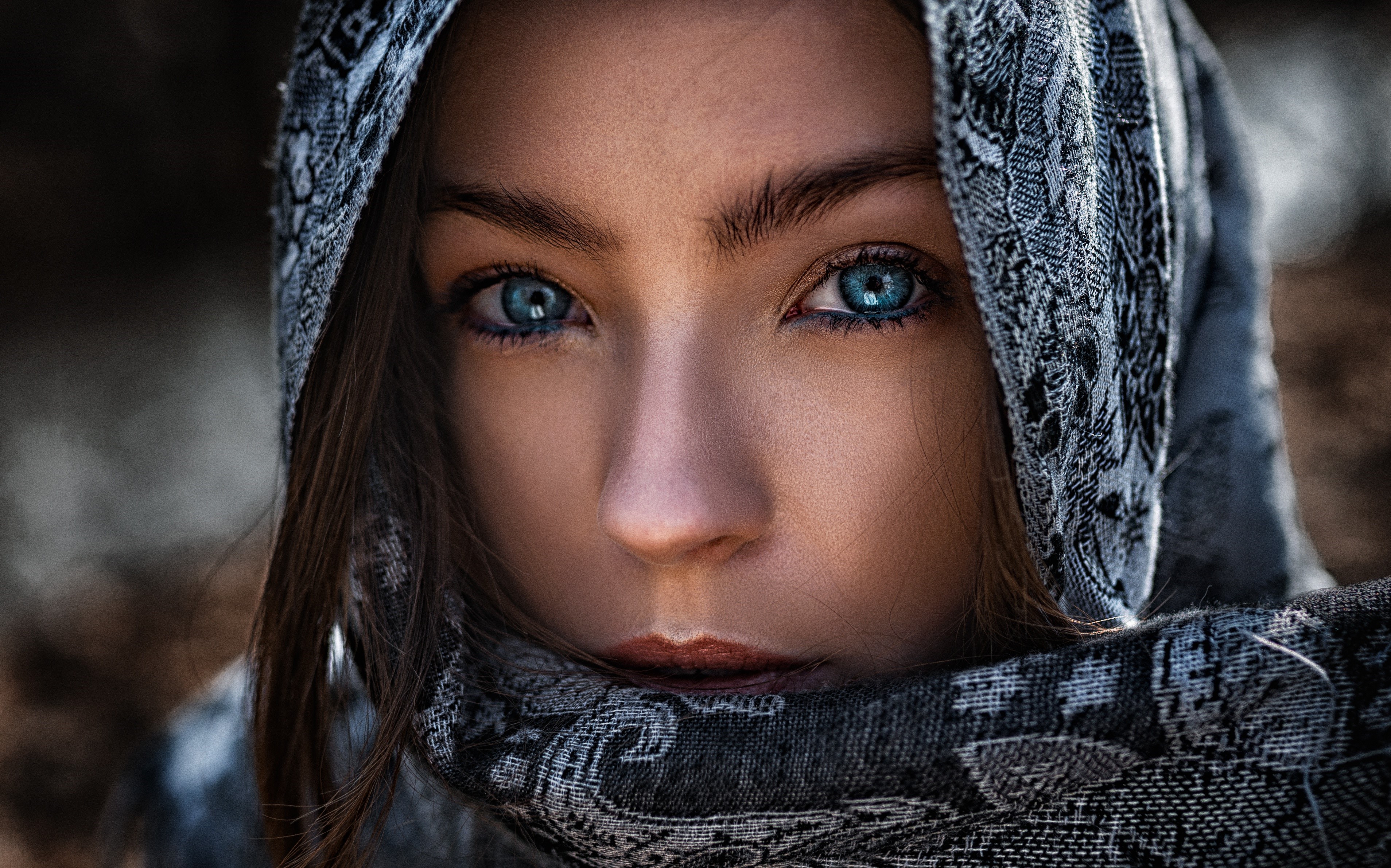 Close-up of a woman's face with blue eyes and a headscarf HD Wallpaper