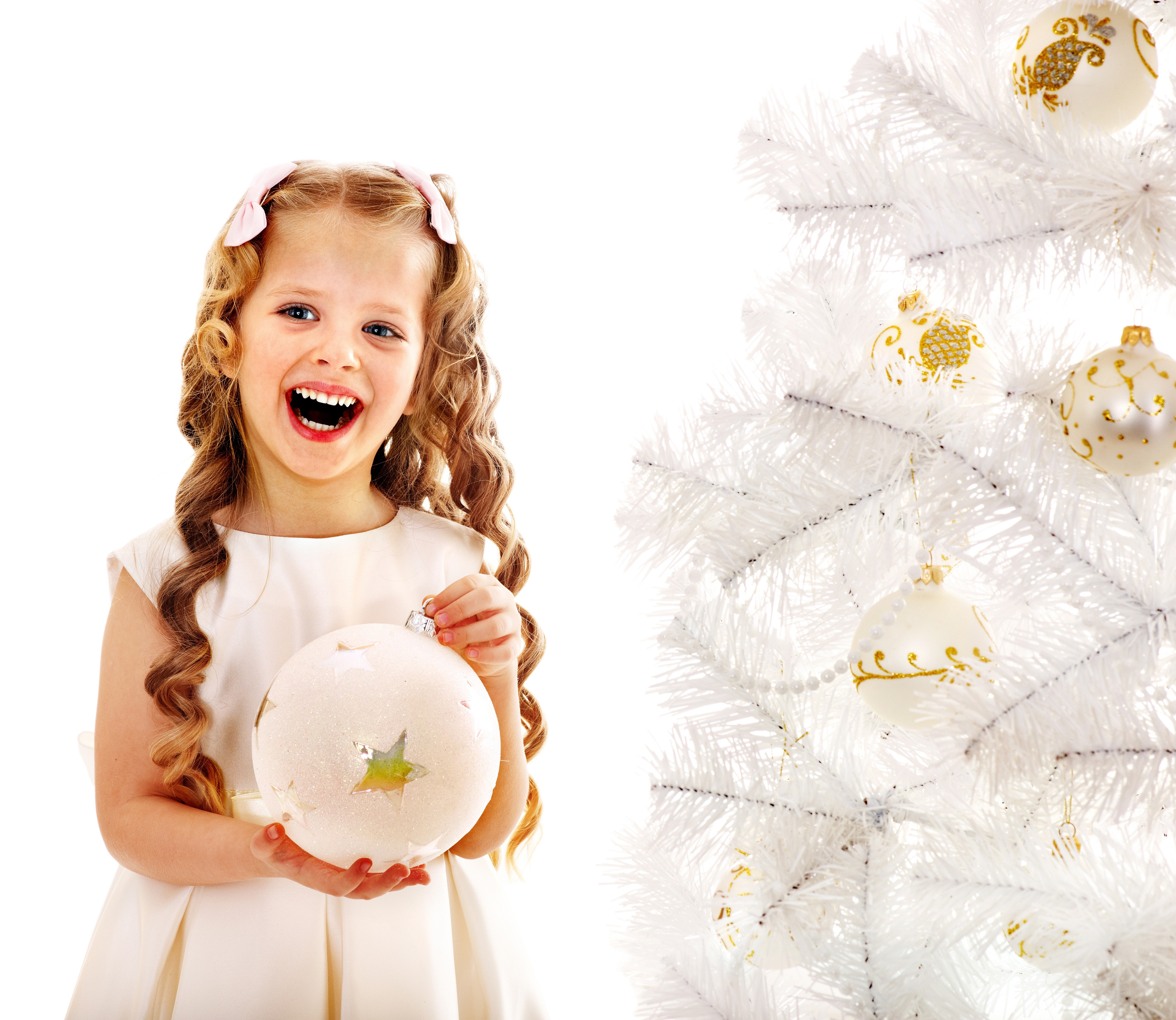 Girl holding Christmas ornament near white tree HD Wallpaper