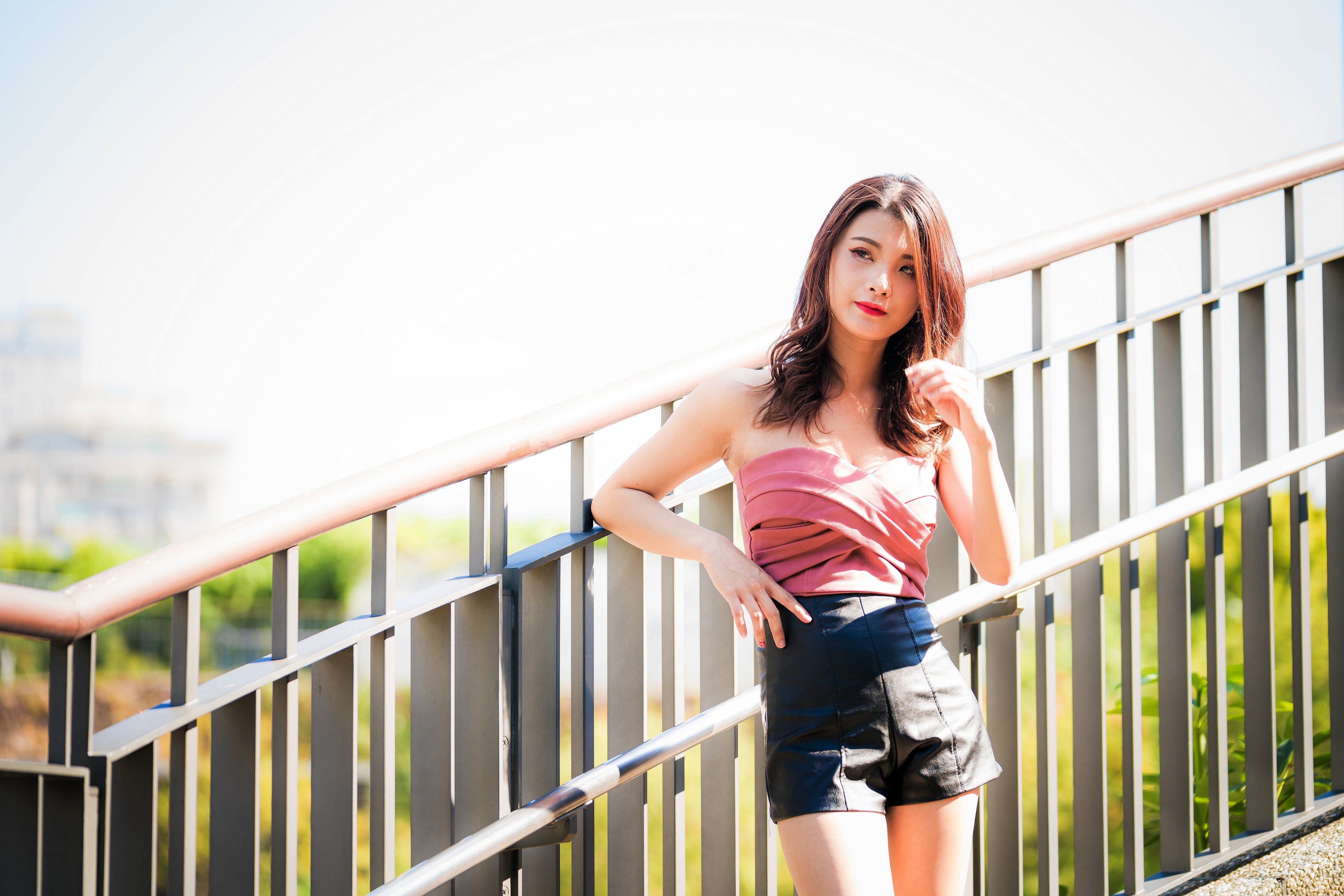 Asian woman in pink top and black shorts posing on stairs HD Wallpaper