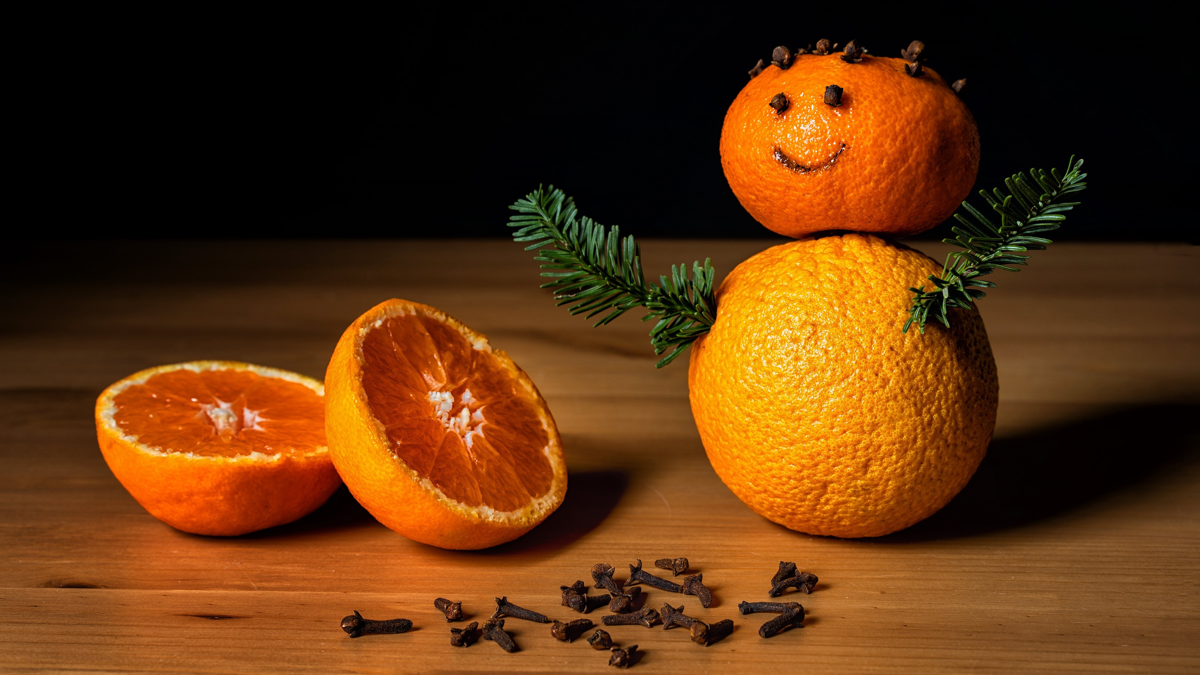 Orange snowman with cloves and pine branches HD Wallpaper