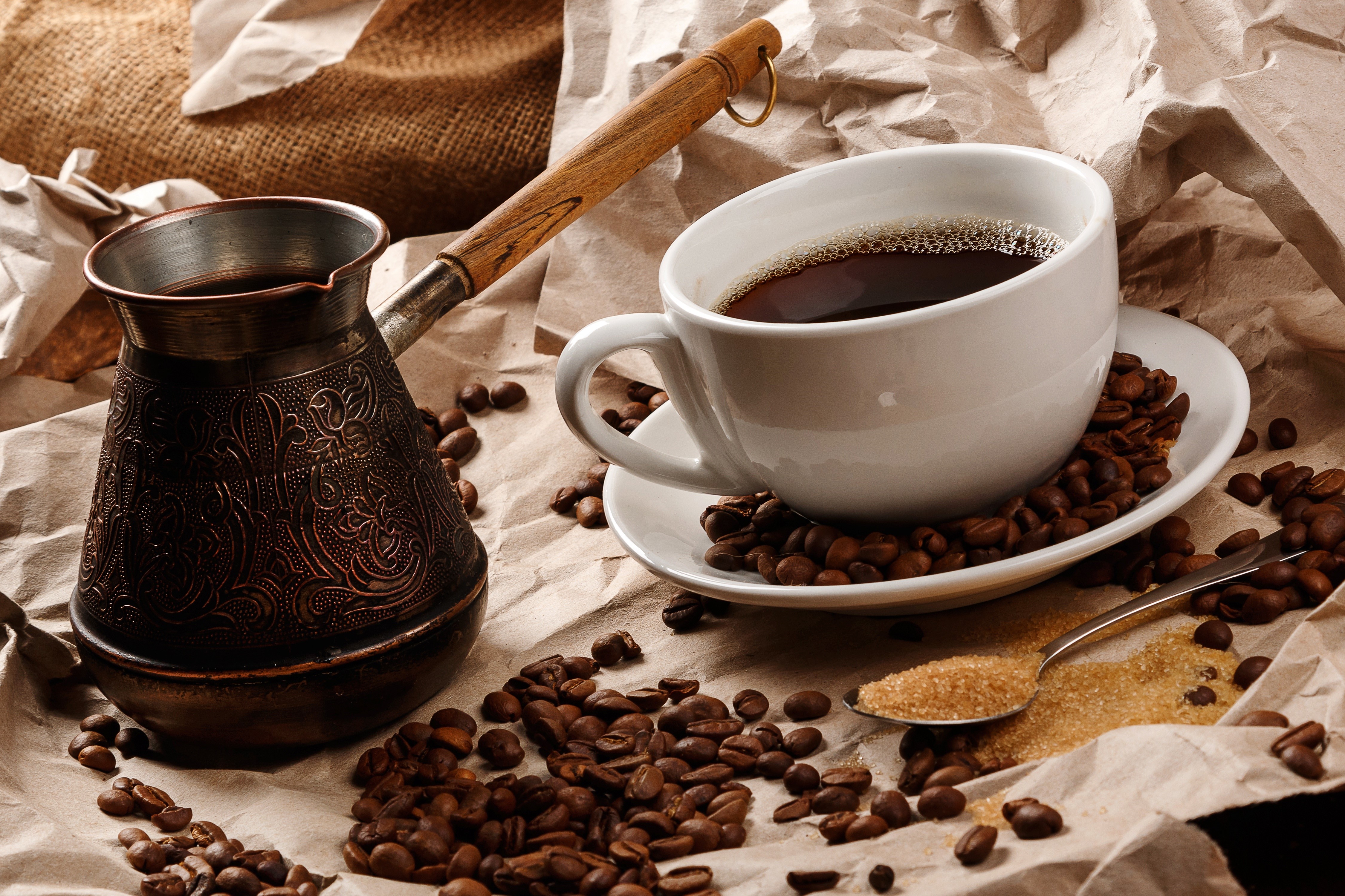 Coffee cup, cezve, coffee beans, and sugar on crumpled paper HD Wallpaper