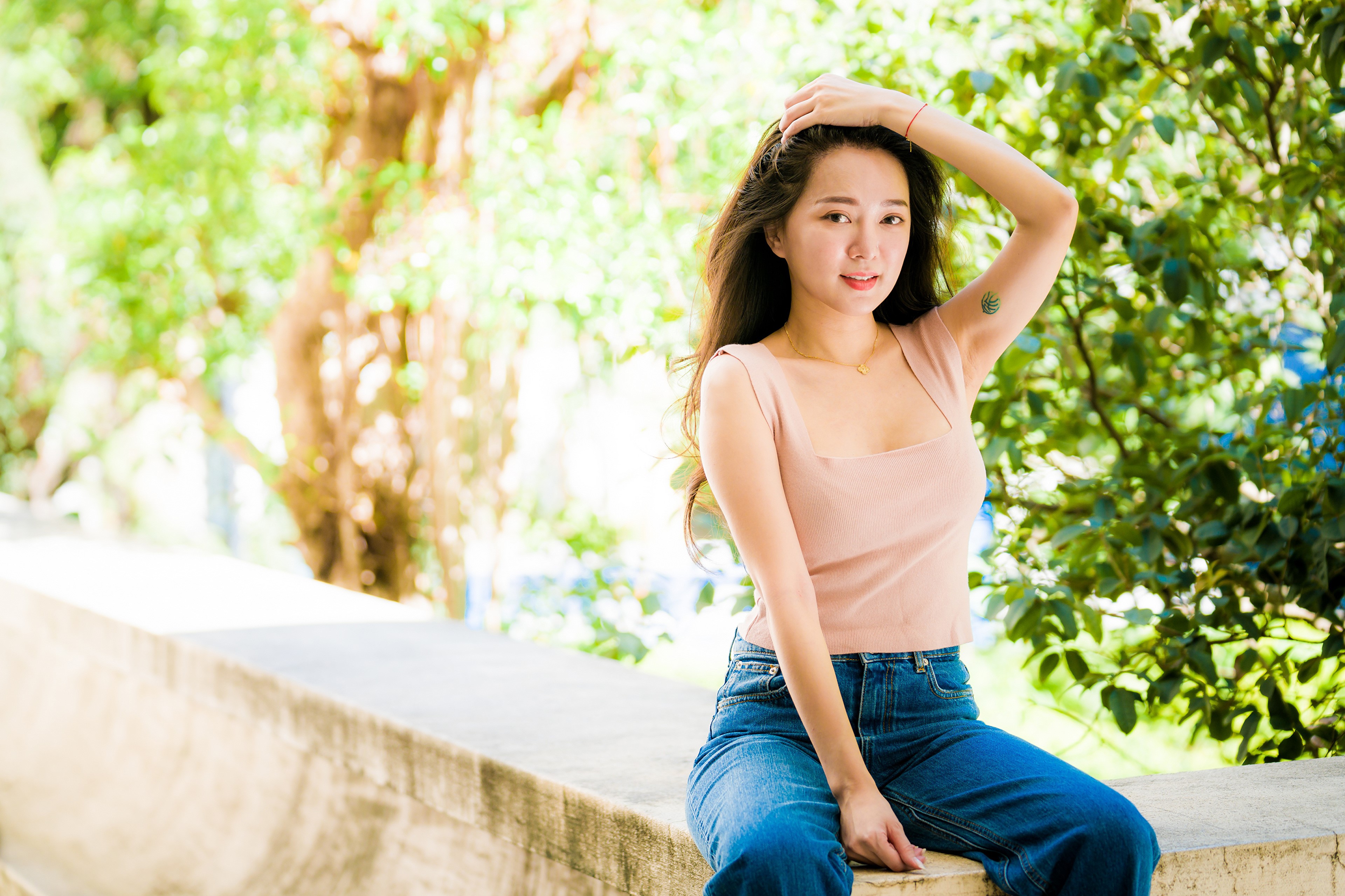 4K Asian Woman Sitting on Concrete Wall HD Wallpaper