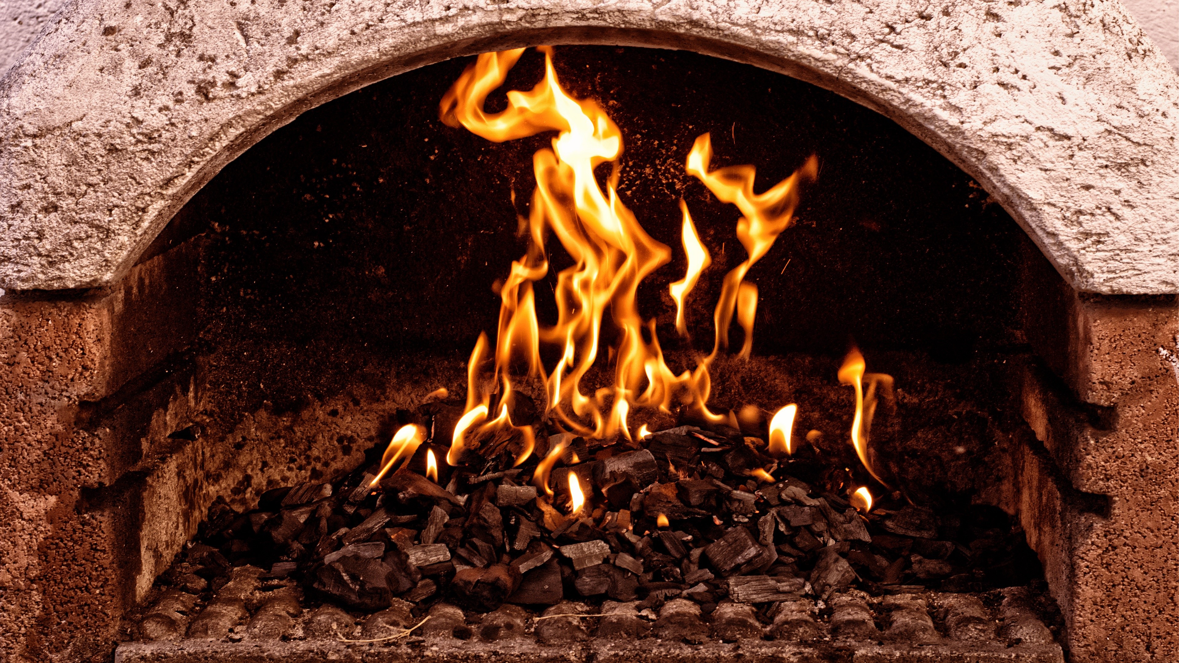 Fire burning in a stone oven HD Wallpaper