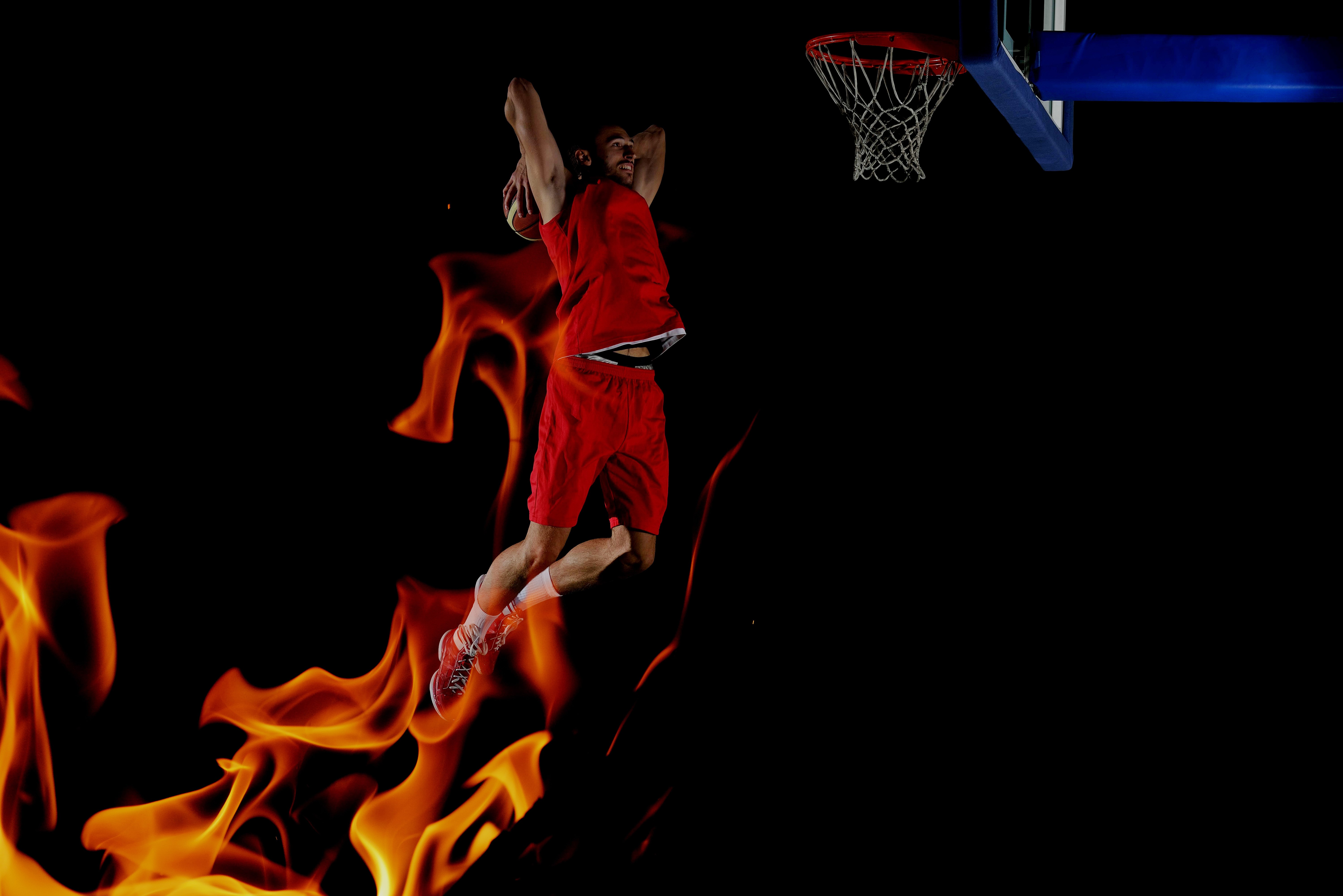 Basketball player dunking with fire HD Wallpaper