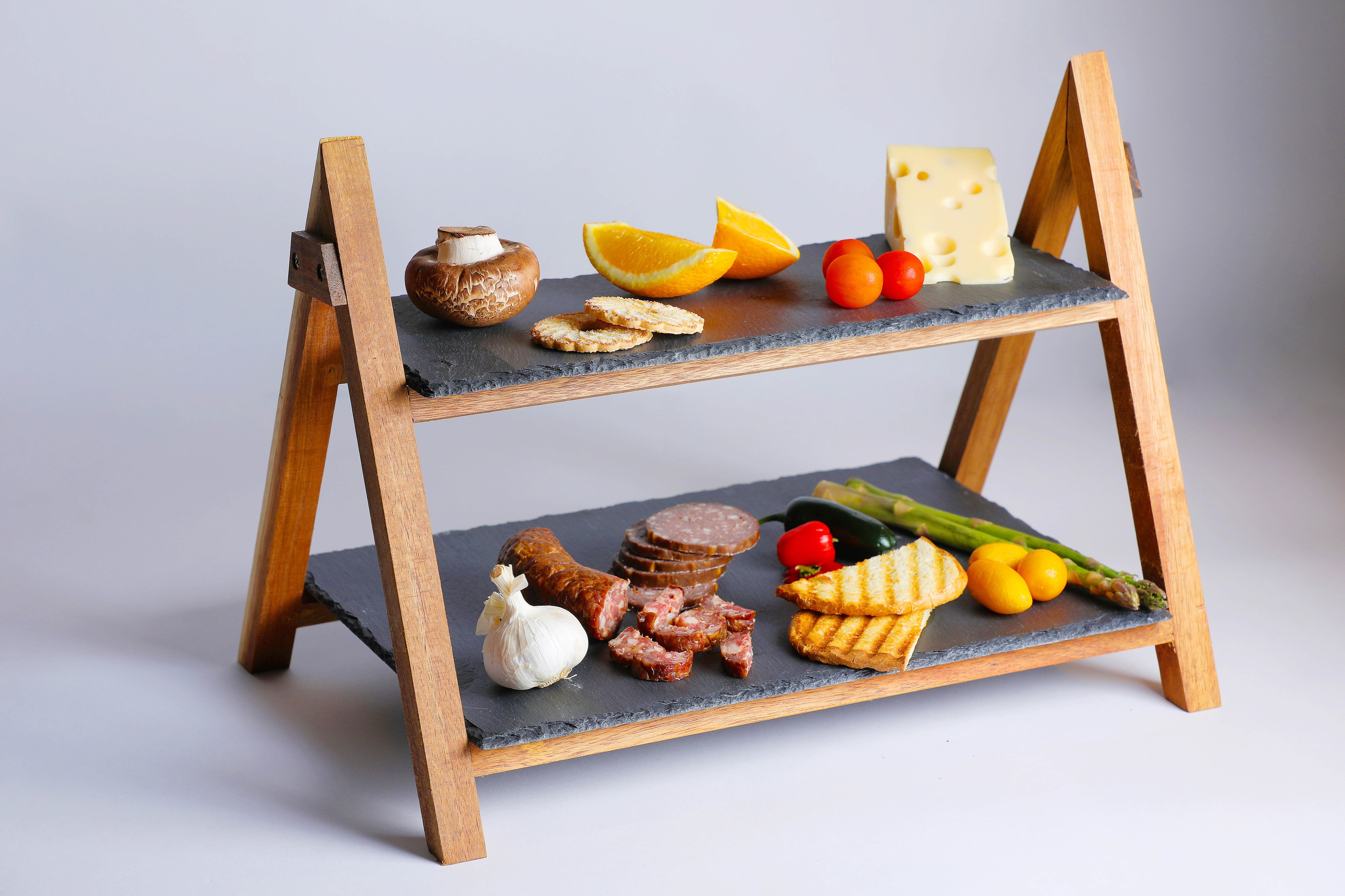 Two-tiered slate serving tray with food HD Wallpaper