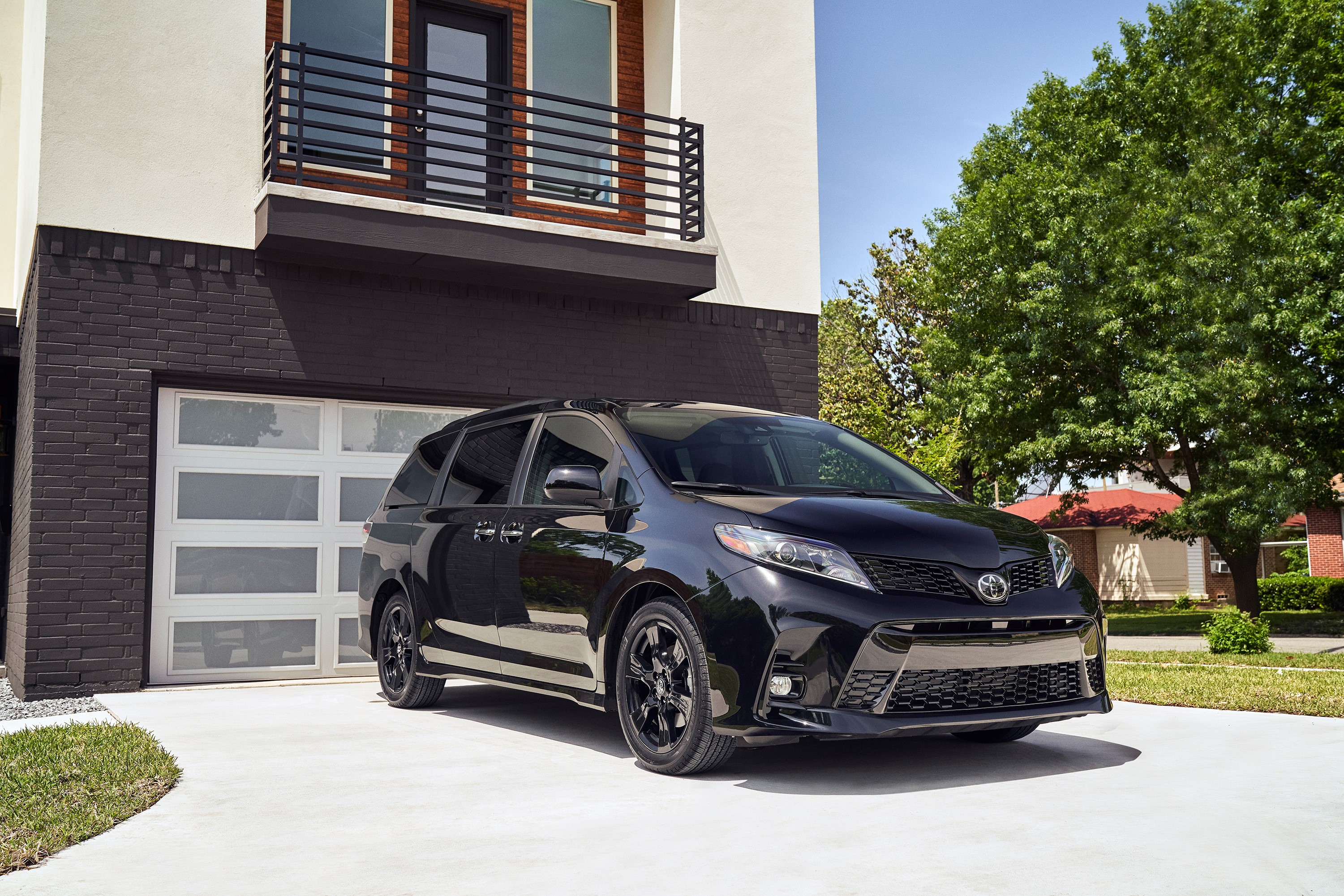 Black Toyota Sienna Nightshade parked in front of a modern house HD Wallpaper