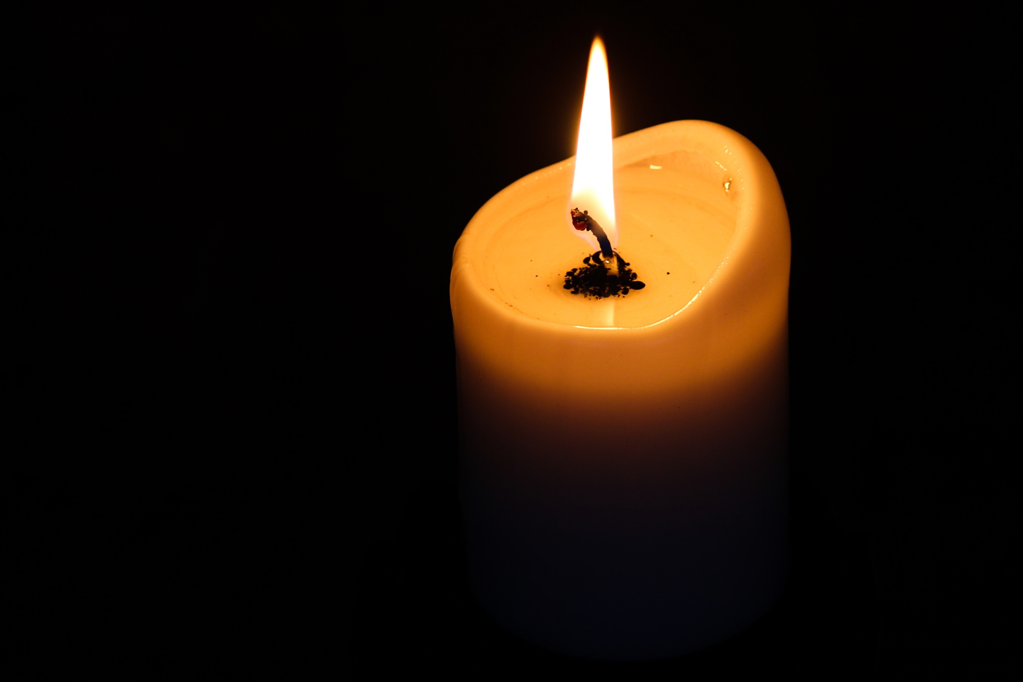 Candle flame burning on a black background HD Wallpaper