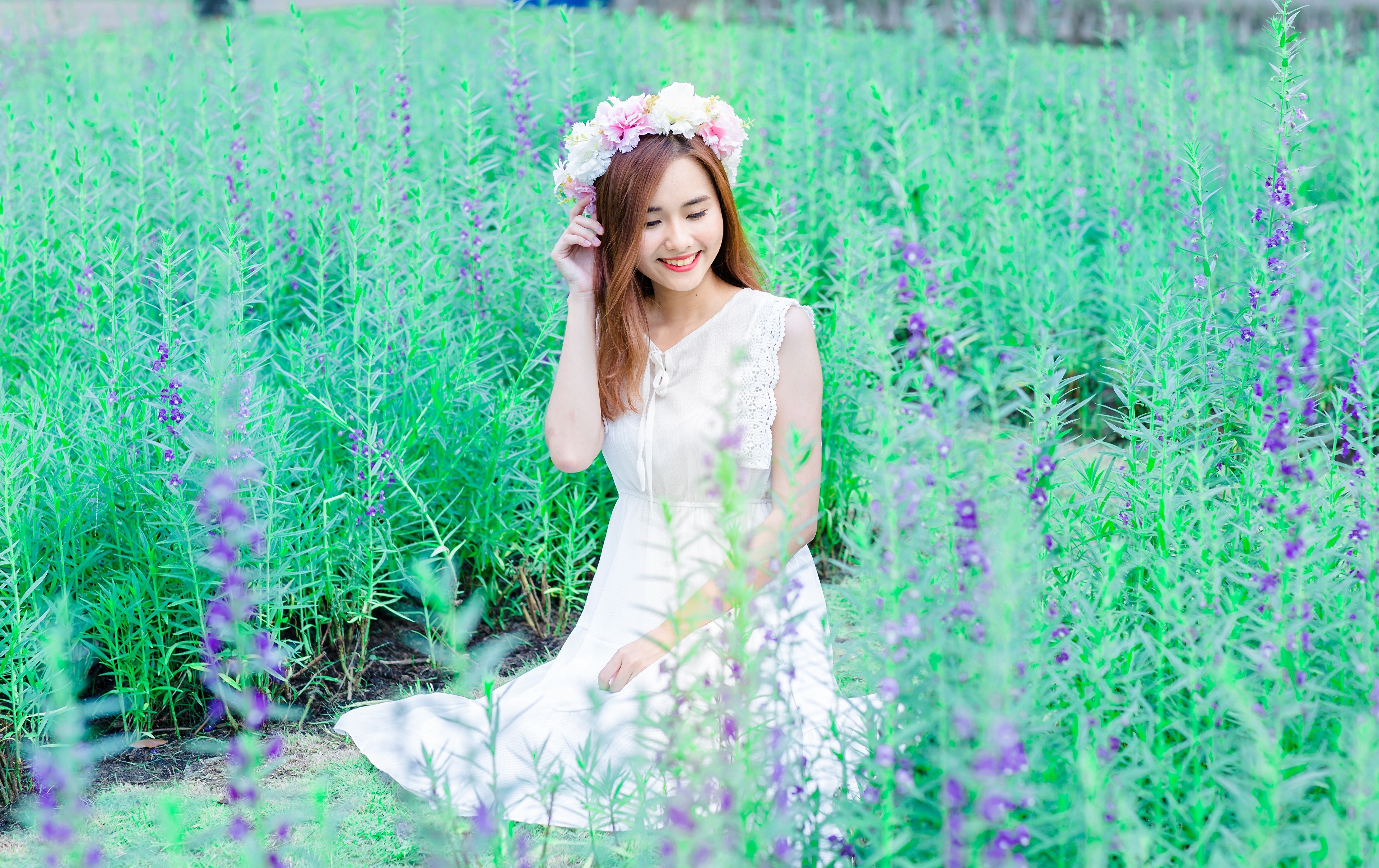 Asian woman with flower wreath in field HD Wallpaper