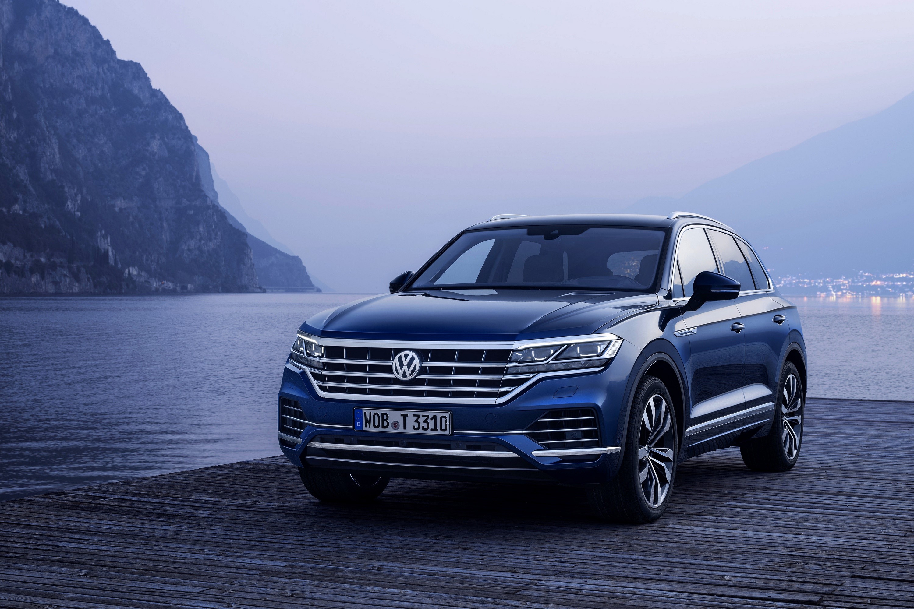 Blue Volkswagen Touareg SUV on a wooden pier by a lake HD Wallpaper