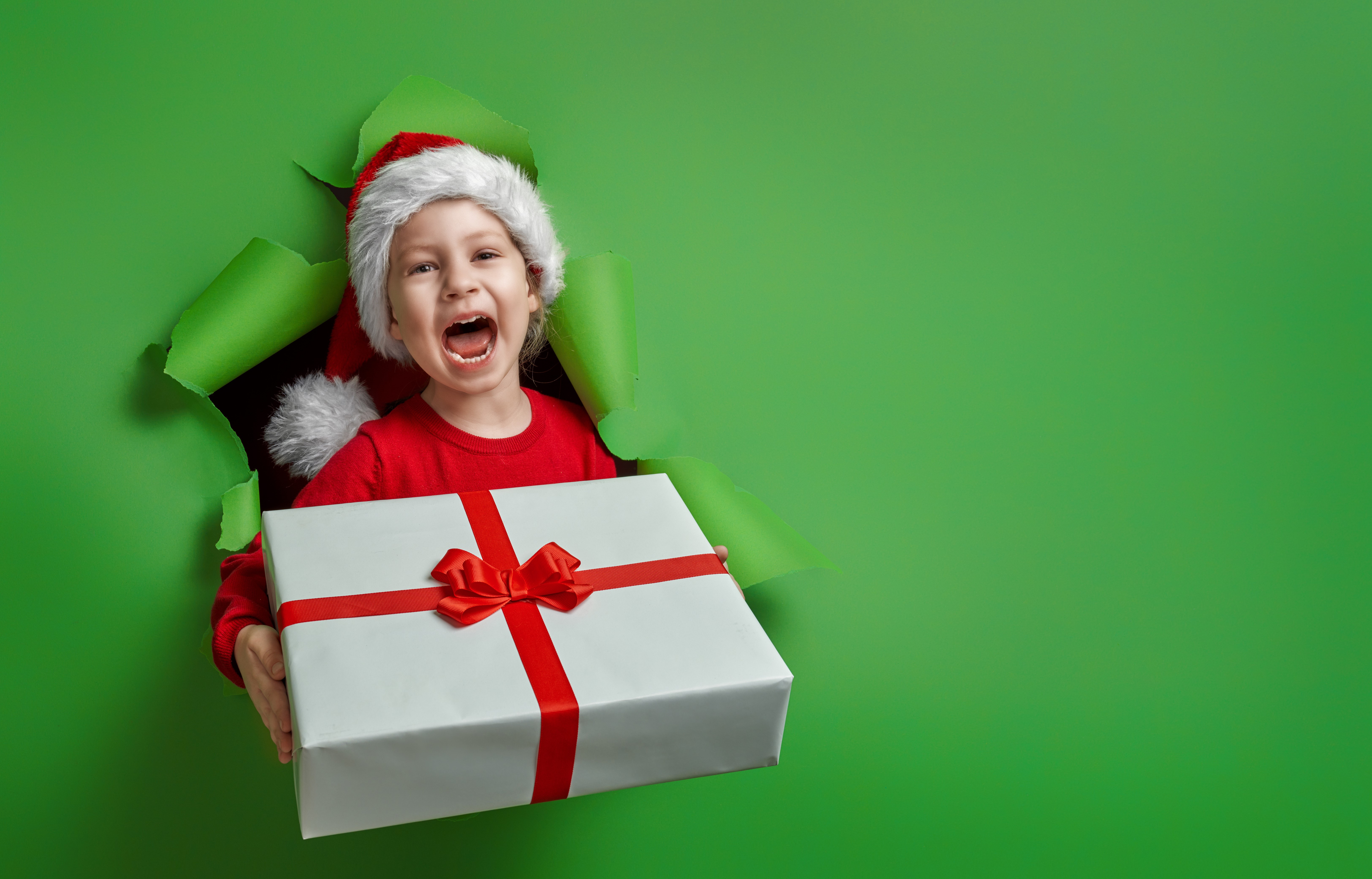 Girl in Santa hat with Christmas gift HD Wallpaper
