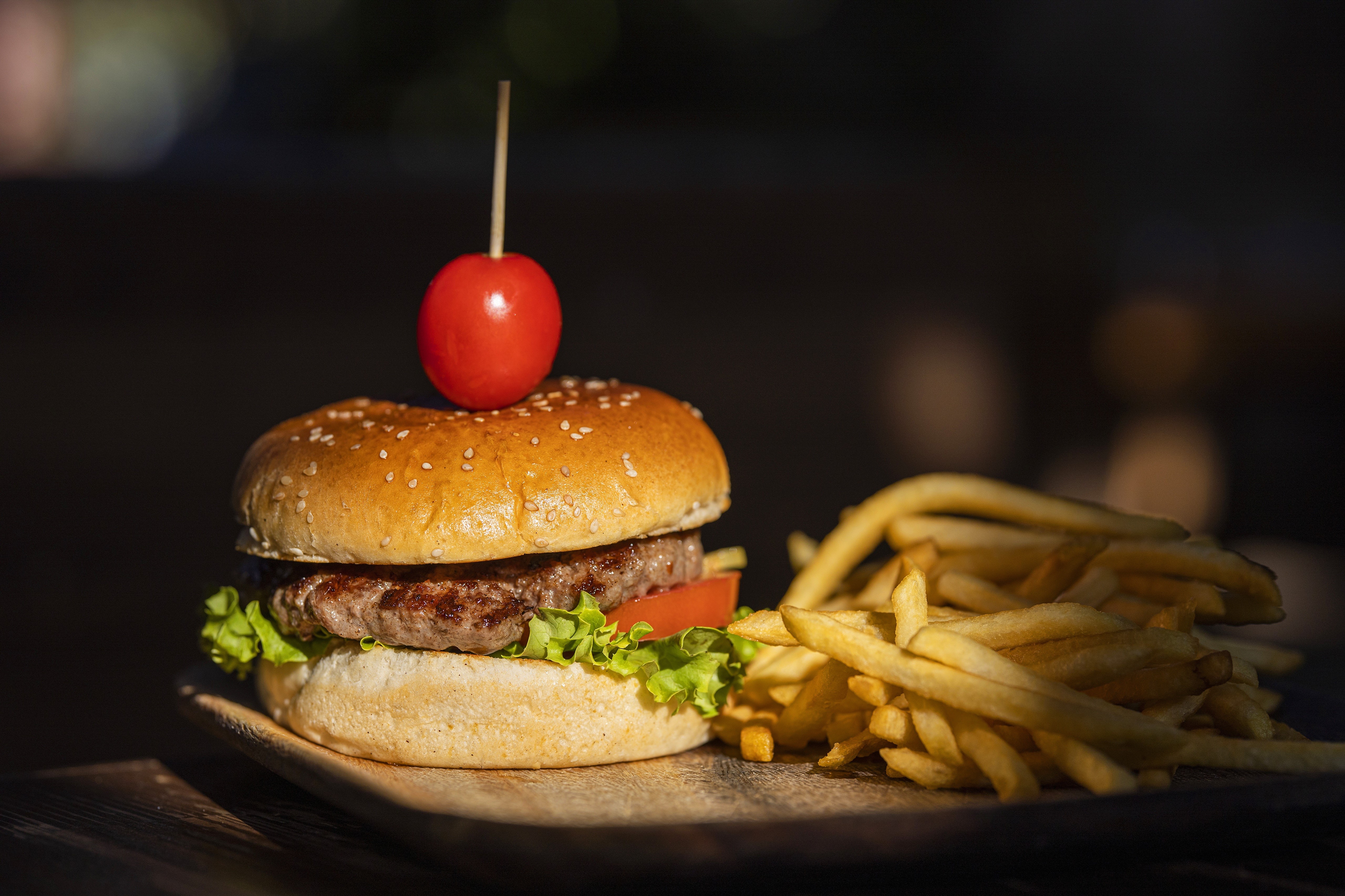Hamburger with French fries and a cherry tomato HD Wallpaper
