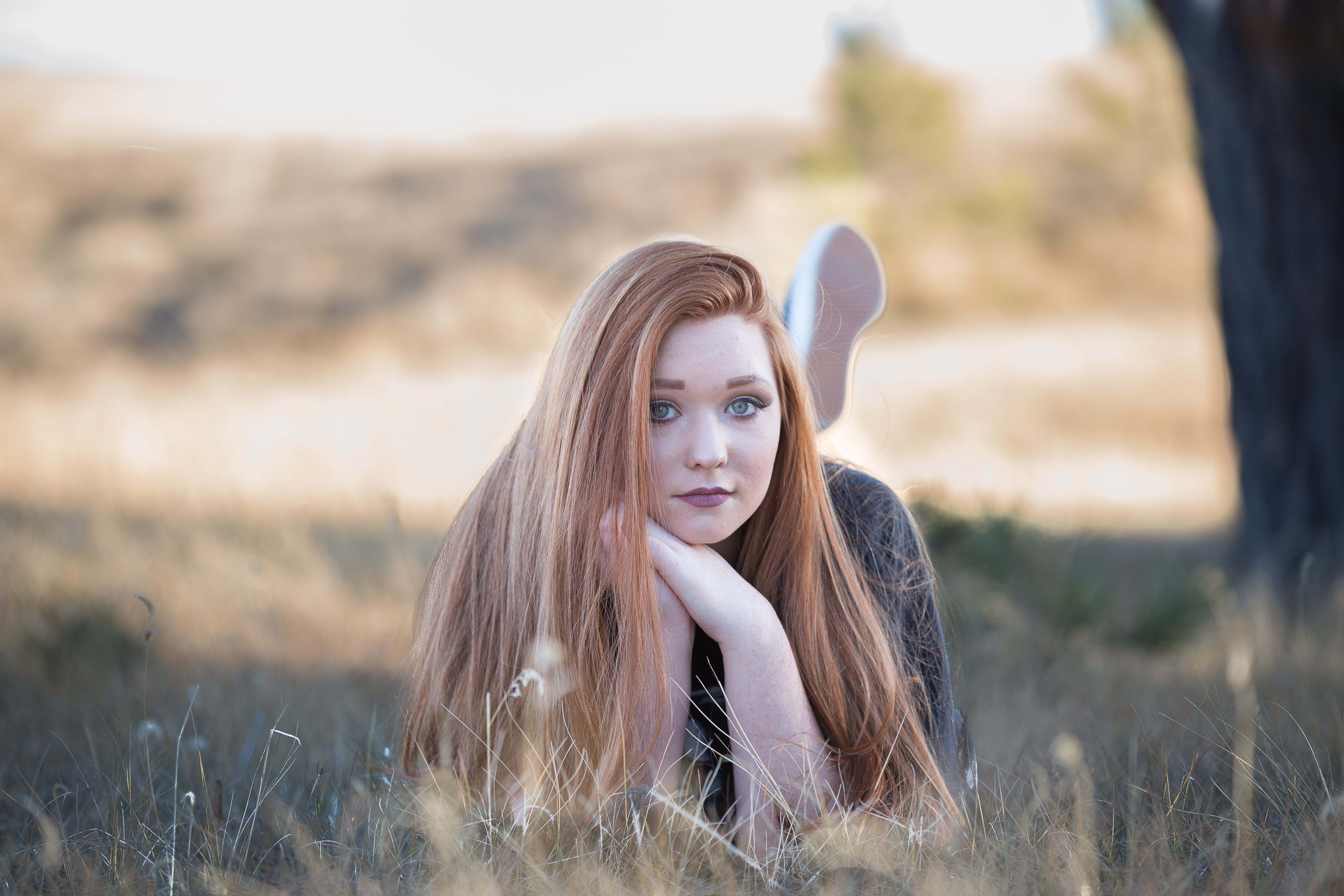 Redhead girl lying in grass HD Wallpaper